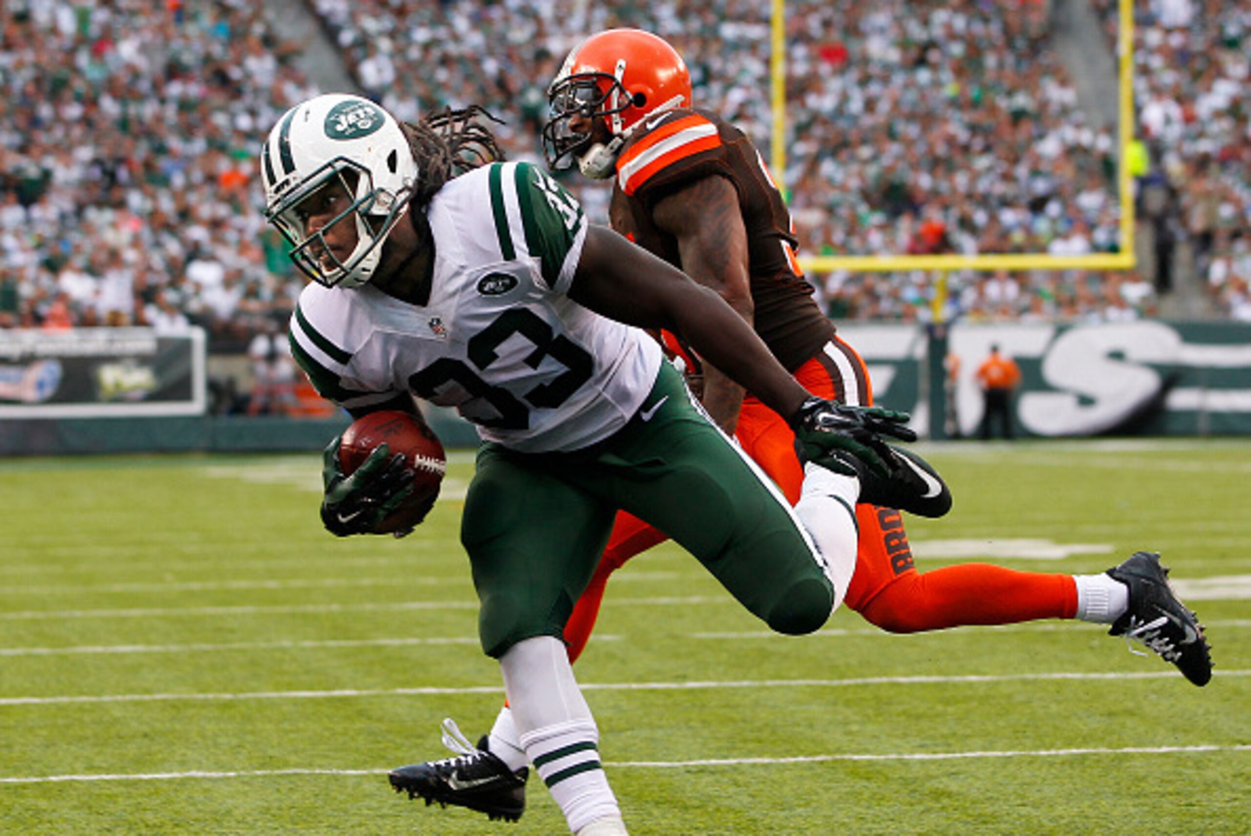 EAST RUTHERFORD, NJ - SEPTEMBER 13: Chris Ivory #33 of the New York Jets scores a touchdown as Donte Whitner #31 of the Cleveland Browns chases during the third quarter of a game at MetLife Stadium on September 13, 2015 in East Rutherford, New Jersey. The