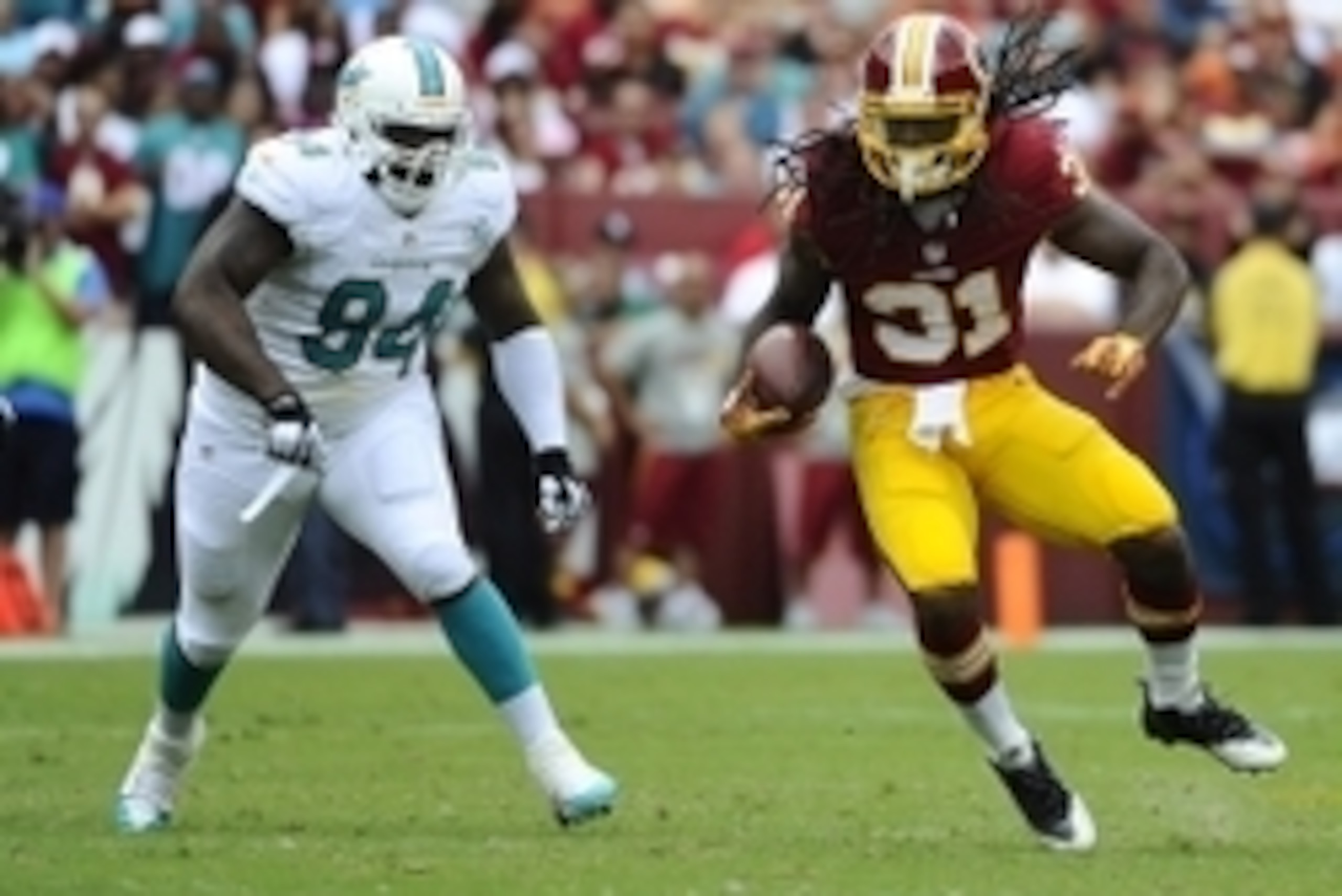 Sep 13, 2015; Landover, MD, USA; Washington Redskins running back Matt Jones (31) rushes the ball as Miami Dolphins defensive tackle C.J. Mosley (94) chases during the first half at FedEx Field. Mandatory Credit: Brad Mills-USA TODAY Sports