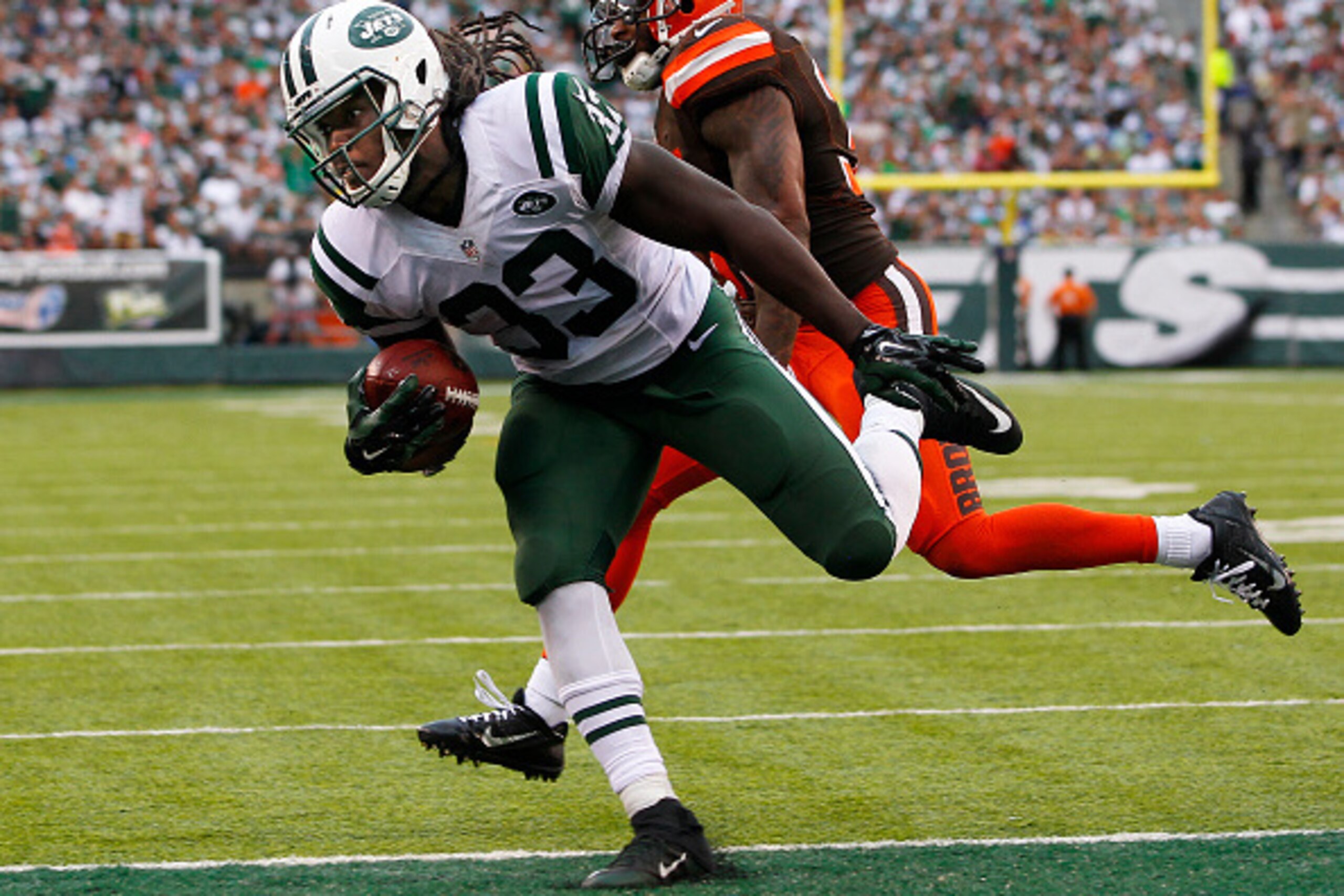 EAST RUTHERFORD, NJ - SEPTEMBER 13: Chris Ivory #33 of the New York Jets scores a touchdown as Donte Whitner #31 of the Cleveland Browns chases during the third quarter of a game at MetLife Stadium on September 13, 2015 in East Rutherford, New Jersey. The