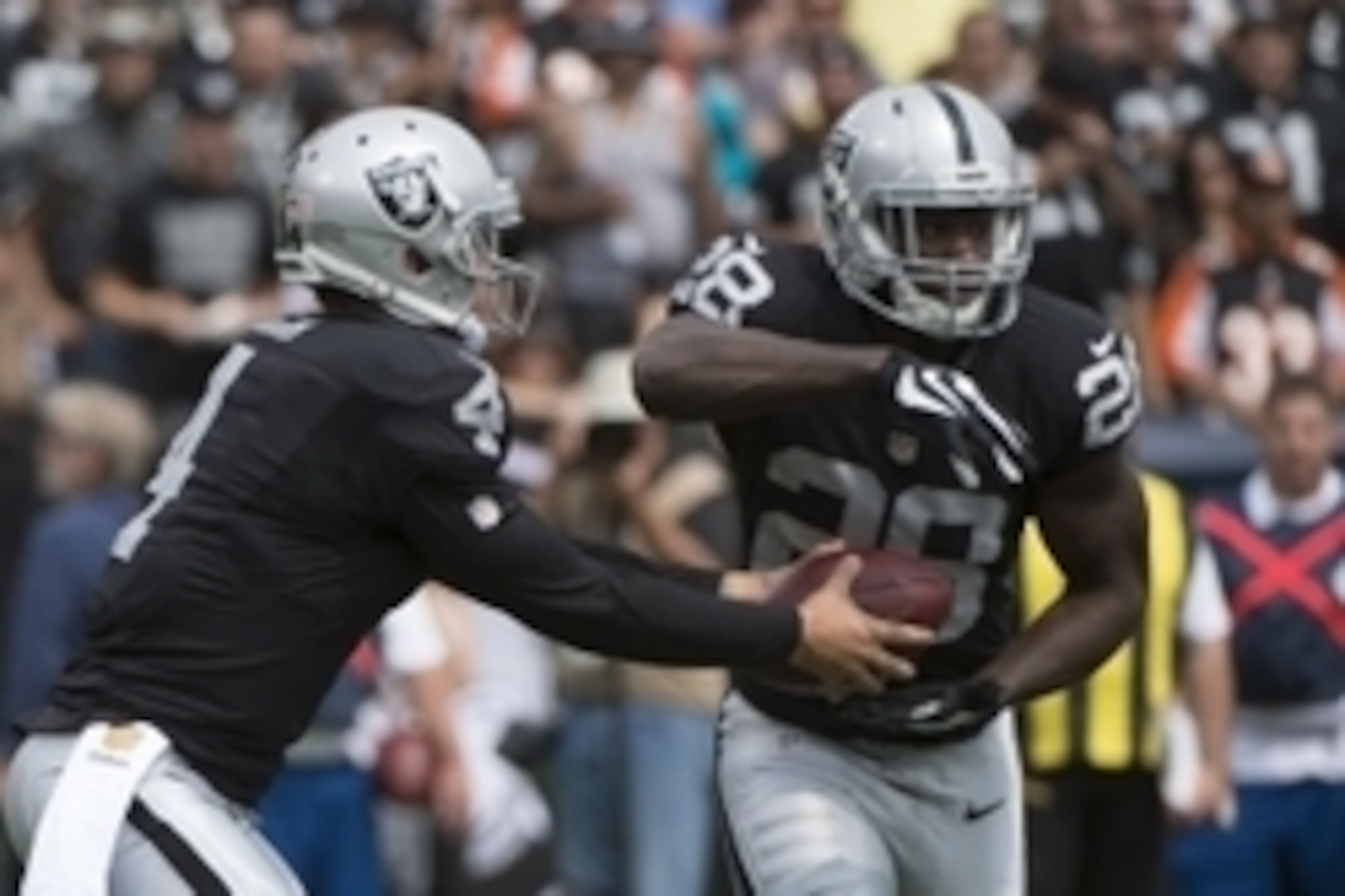 September 13, 2015; Oakland, CA, USA; Oakland Raiders running back Latavius Murray (28) receives the hand off from quarterback Derek Carr (4) against the Cincinnati Bengals during the first quarter at O.co Coliseum. Mandatory Credit: Kyle Terada-USA TODAY