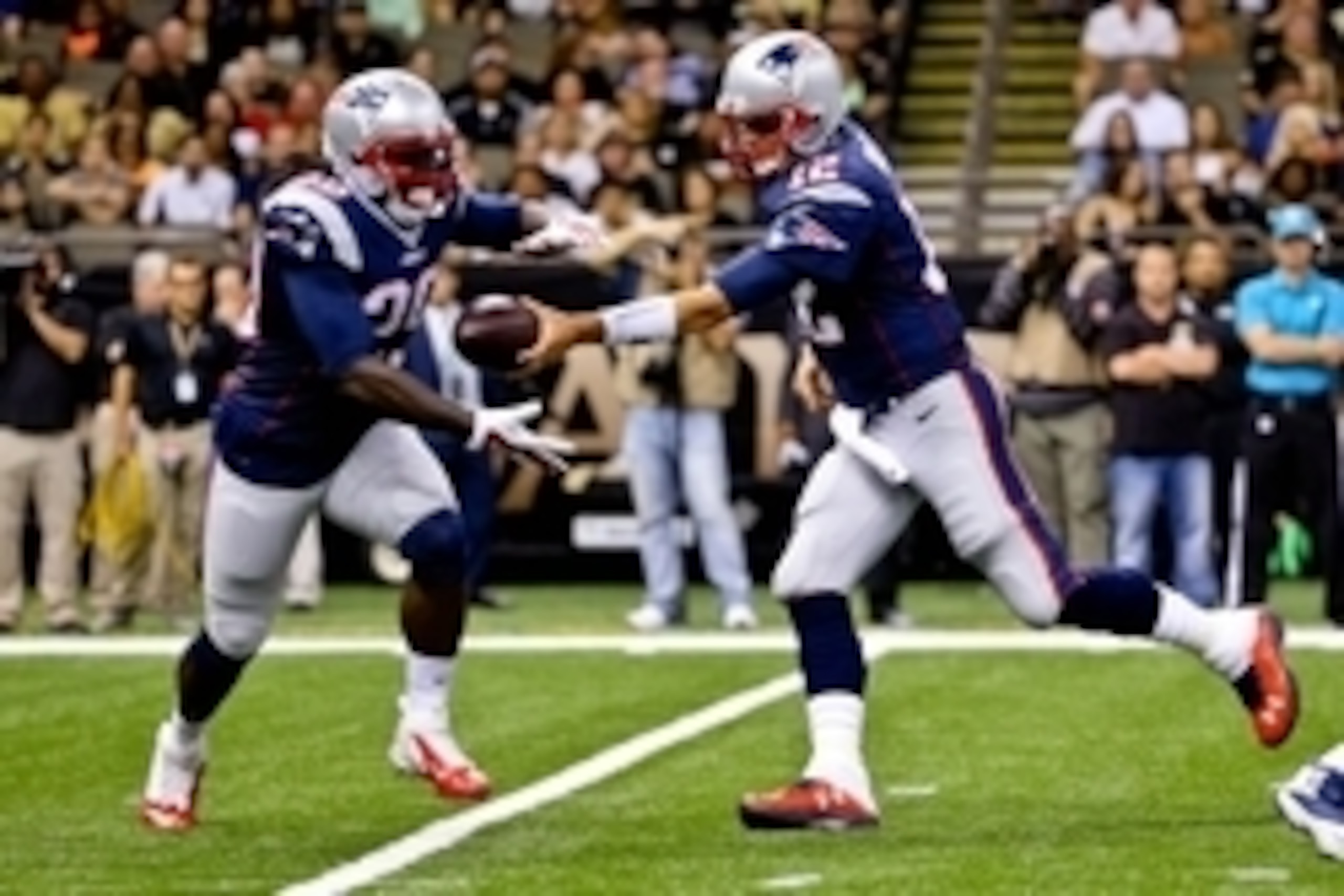 Aug 22, 2015; New Orleans, LA, USA; New England Patriots quarterback Tom Brady (12) hands off to running back LeGarrette Blount (29) against the New Orleans Saints during the first half of a preseason game at the Mercedes-Benz Superdome. Mandatory Credit: