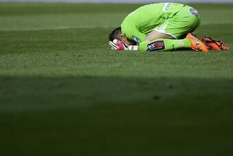 Granada's goalkeeper Roberto Fernandez bends on the ground during the Spanish league football match Granada FC v Sevilla FC at Nuevo Los Carmenes stadium in Granada  on April 19, 2015.  AFP PHOTO / JORGE GUERRERO        (Photo credit should read Jorge Gue