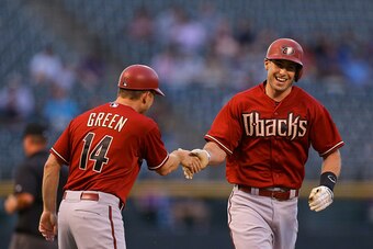 DENVER, CO - SEPTEMBER 1:  Paul Goldschmidt #44 of the Arizona Diamondbacks smiles as he is congratulated on his solo home run by third base coach Andy Green during the first inning against the Colorado Rockies at Coors Field on September 1, 2015 in Denve