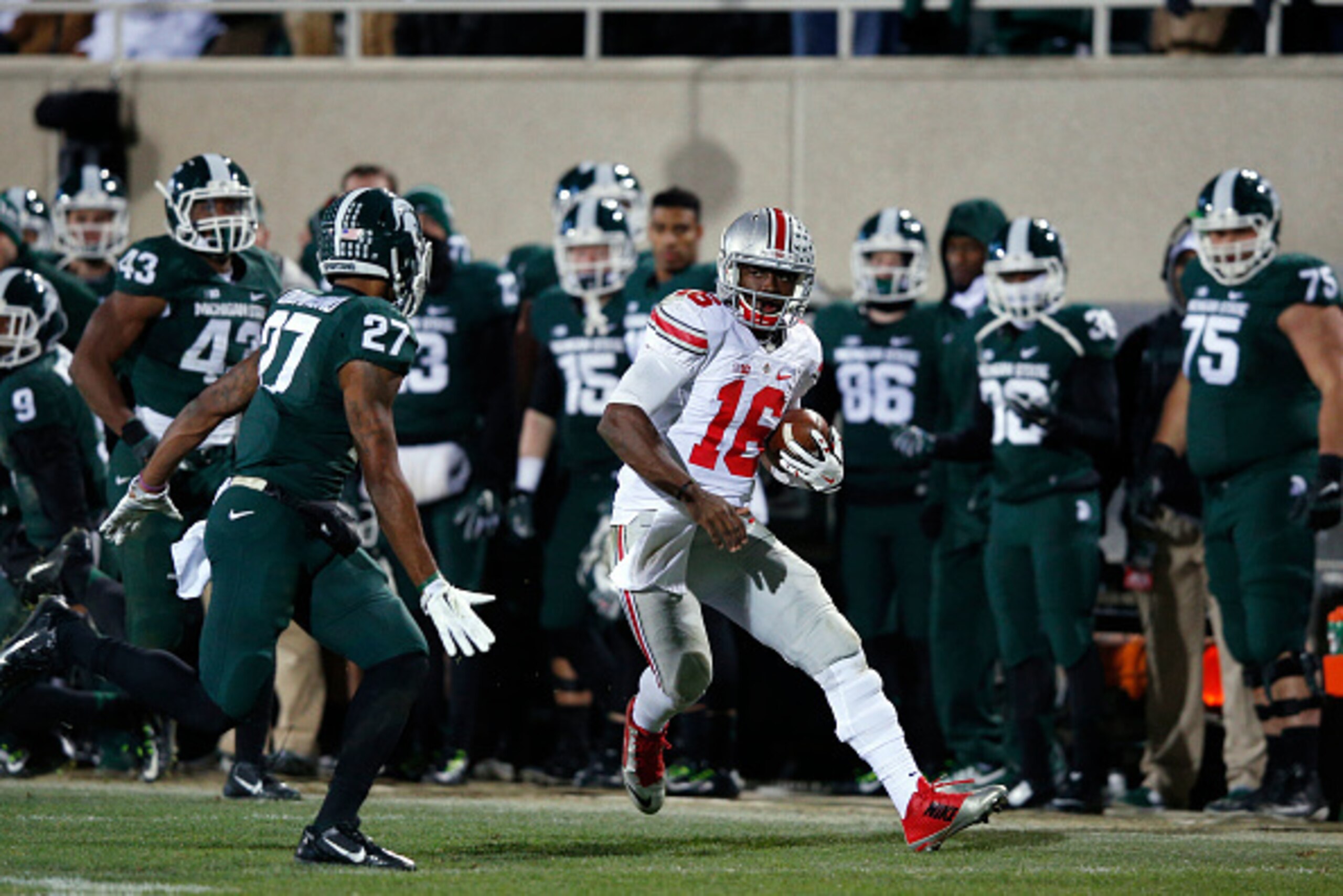 EAST LANSING, MI - NOVEMBER 8: J.T. Barrett #16 of the Ohio State Buckeyes runs for a 55-yard gain against the Michigan State Spartans during the game at Spartan Stadium on November 8, 2014 in East Lansing, Michigan. Ohio State defeated Michigan State 49-