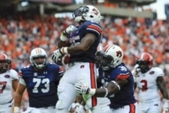 Sep 12, 2015; Auburn, AL, USA; Auburn Tigers running back Peyton Barber (25) celebrates his game-winning touchdown during overtime against the Jacksonville State Gamecocks at Jordan Hare Stadium. Auburn won 27-20. Mandatory Credit: Shanna Lockwood-USA TOD