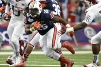 Sep 5, 2015; Atlanta, GA, USA; Auburn Tigers running back Peyton Barber (25) carries the ball past Louisville Cardinals linebacker James Burgess (13) and Drew Bailey (14) during the second quarter in the 2015 Chick-fil-A Kickoff Game at the Georgia Dome. 