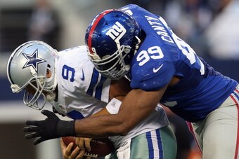 ARLINGTON, TX - OCTOBER 28:  Tony Romo #9 of the Dallas Cowboys is sacked by Chris Canty #99 of the New York Giants at Cowboys Stadium on October 28, 2012 in Arlington, Texas.  (Photo by Ronald Martinez/Getty Images)