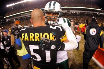PITTSBURGH, PA - JANUARY 23:  James Farrior #51 of the Pittsburgh Steelers is congratulated by Jason Taylor #99 of the New York Jets after the Steelers defeated the Jets 24 to 19 in the 2011 AFC Championship game at Heinz Field on January 23, 2011 in Pitt