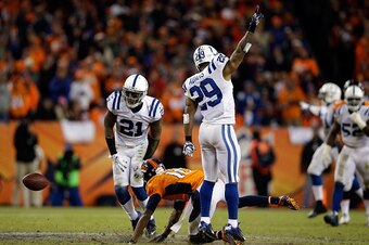 DENVER, CO - JANUARY 11:  Vontae Davis #21 and  Mike Adams #29 of the Indianapolis Colts and  Emmanuel Sanders #10 of the Denver Broncos react after a broken play  during a 2015 AFC Divisional Playoff game at Sports Authority Field at Mile High on January
