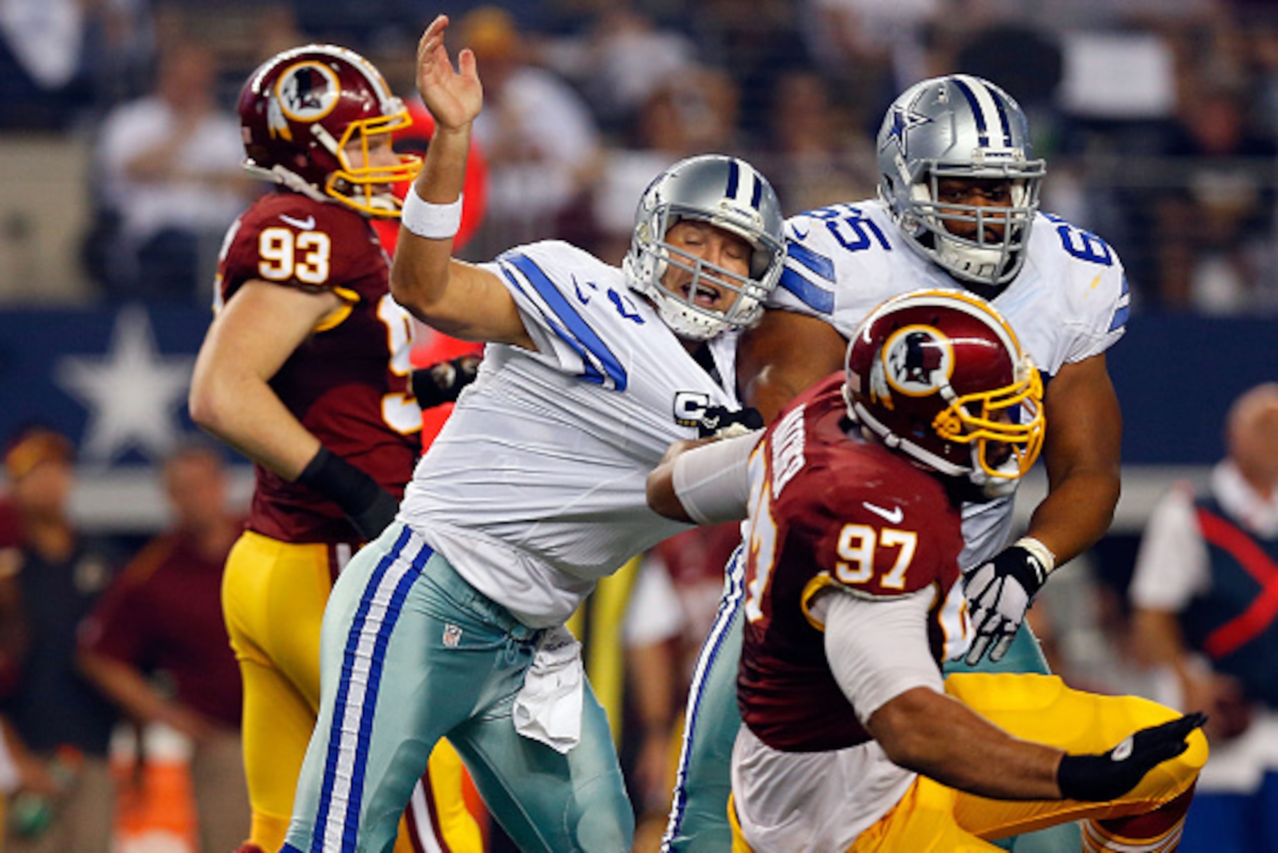 ARLINGTON, TX - OCTOBER 27: Tony Romo #9 of the Dallas Cowboys is hurled to the ground by Jason Hatcher #97 of the Washington Redskins during the first half at AT&T Stadium on October 27, 2014 in Arlington, Texas. (Photo by Tom Pennington/Getty Images) ARLINGTON, TX - OCTOBER 27: Tony Romo #9 of the Dallas Cowboys is hurled to the ground by Jason Hatcher #97 of the Washington Redskins during the first half at AT&T Stadium on October 27, 2014 in Arlington, Texas. (Photo by Tom Pennington/Getty Images)