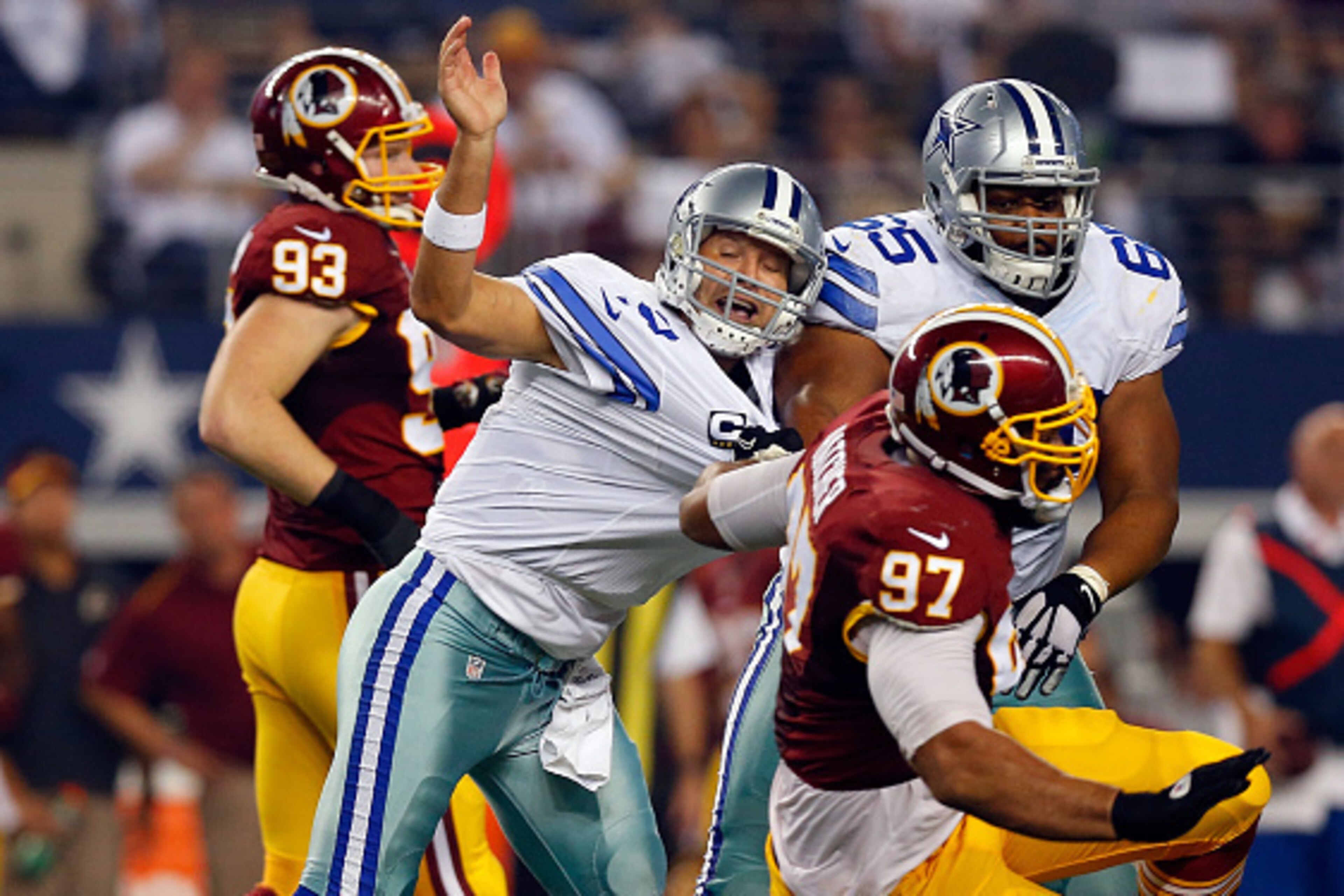 ARLINGTON, TX - OCTOBER 27: Tony Romo #9 of the Dallas Cowboys is hurled to the ground by Jason Hatcher #97 of the Washington Redskins during the first half at AT&T Stadium on October 27, 2014 in Arlington, Texas. (Photo by Tom Pennington/Getty Images) ARLINGTON, TX - OCTOBER 27: Tony Romo #9 of the Dallas Cowboys is hurled to the ground by Jason Hatcher #97 of the Washington Redskins during the first half at AT&T Stadium on October 27, 2014 in Arlington, Texas. (Photo by Tom Pennington/Getty Images)
