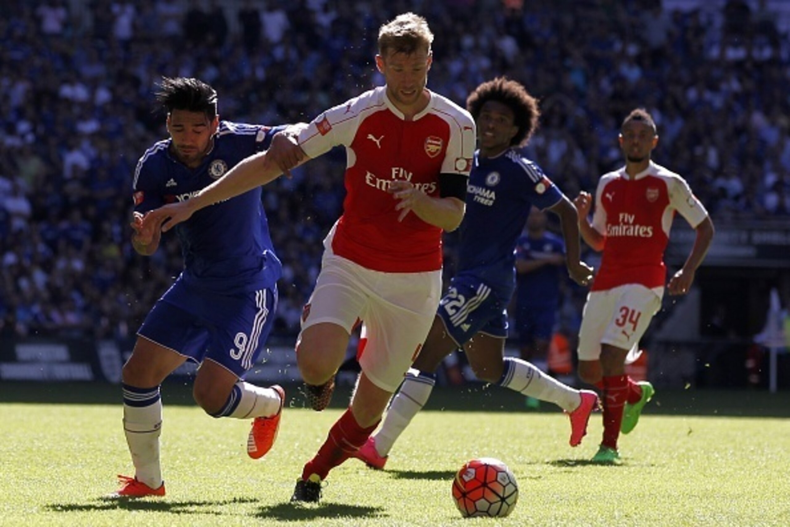 Arsenal's German defender Per Mertesacker vies with Chelsea's Colombian striker Radamel Falcao (L) during the FA Community Shield football match between Arsenal and Chelsea at Wembley Stadium in north London on August 2, 2015. Arsenal won the game 1-0. AF