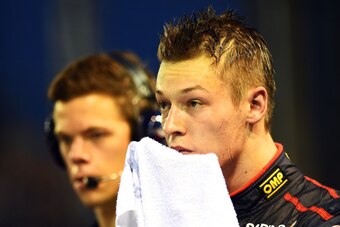 SINGAPORE - SEPTEMBER 20:  Daniil Kvyat of Russia and Scuderia Toro Rosso wipes his face with a towel during final practice ahead of the Singapore Formula One Grand Prix at Marina Bay Street on September 20, 2014 in Singapore, Singapore.  (Photo by Lars B