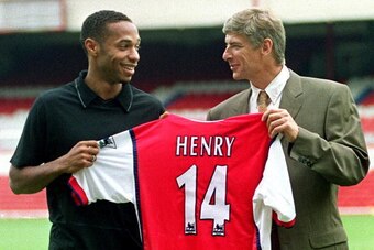 LONDON, UNITED KINGDOM - AUGUST 3:  Striker Thierry Henry (L) holds up his shirt with Manager Arsene Wenger having been signed for Arsenal 03 August, 1999 from Juventus for an undisclosed fee. The 21-year old French international, who played under Arsene 