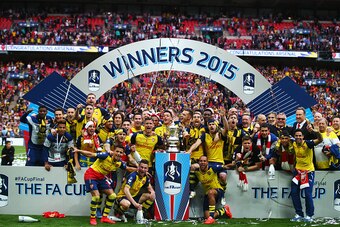 LONDON, ENGLAND - MAY 30:  Arsenal players celebrate with the trophy after the FA Cup Final between Aston Villa and Arsenal at Wembley Stadium on May 30, 2015 in London, England. Arsenal beat Aston Villa 4-0.  (Photo by Clive Rose/Getty Images)