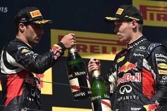Third placed Infiniti Red Bull Racing's Australian driver Daniel Ricciardo (L) and second placed Infiniti Red Bull Racing's Russian driver Daniil Kvyat celebrate with champagne on the podium after the Hungarian Formula One Grand Prix at the Hungaroring ci