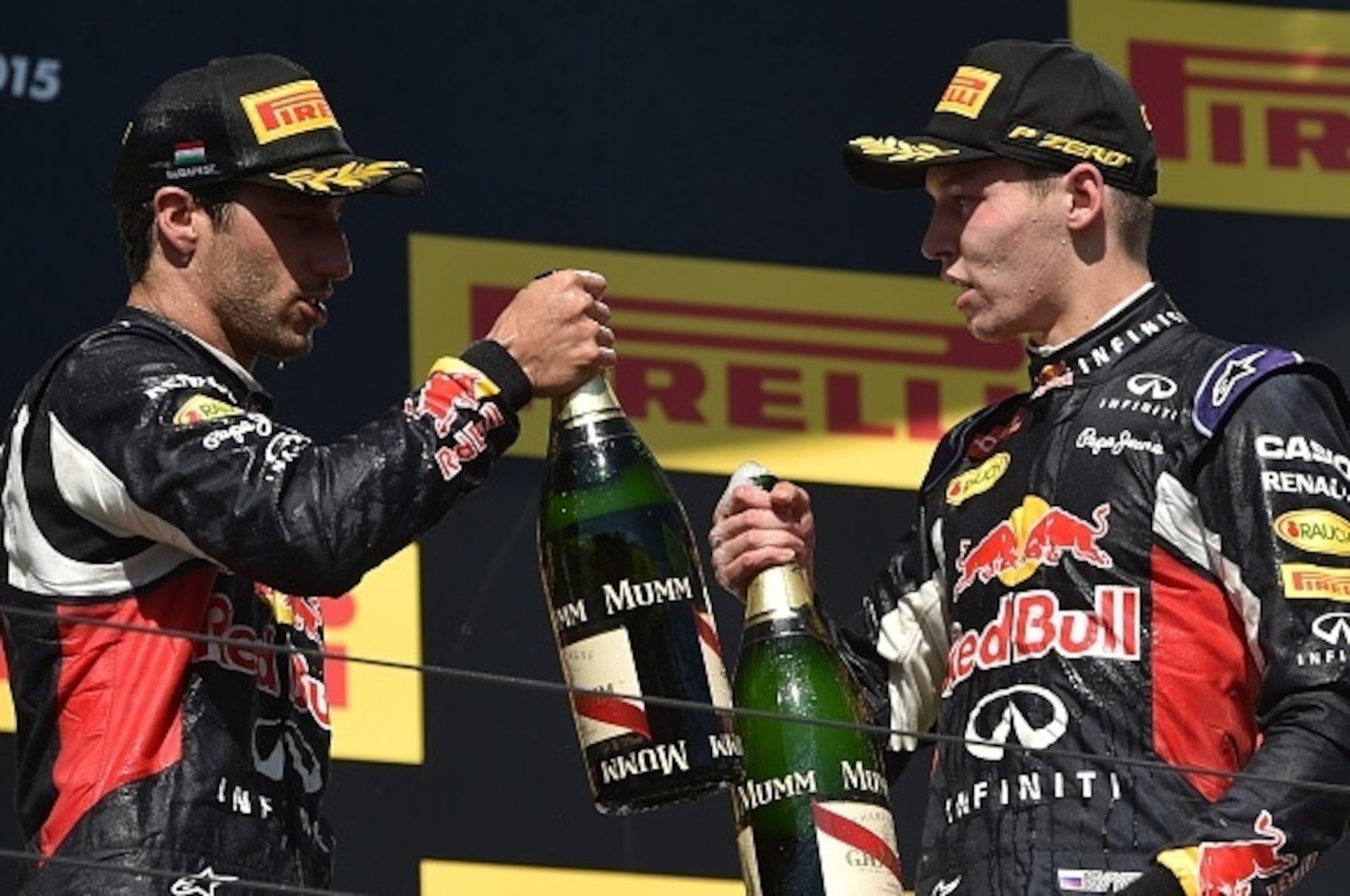 Third placed Infiniti Red Bull Racing's Australian driver Daniel Ricciardo (L) and second placed Infiniti Red Bull Racing's Russian driver Daniil Kvyat celebrate with champagne on the podium after the Hungarian Formula One Grand Prix at the Hungaroring ci