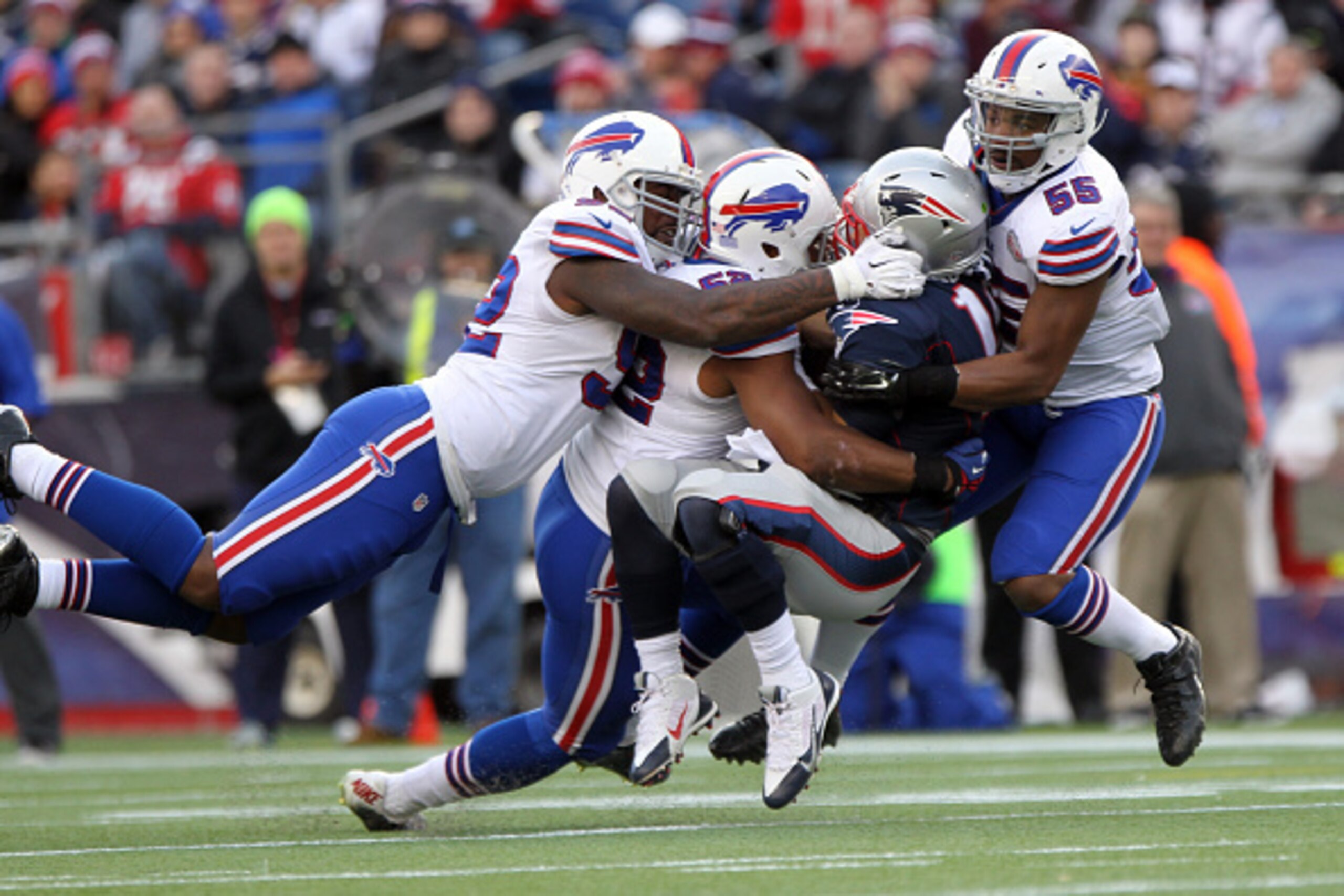 FOXBORO, MA - DECEMBER 28: Jimmy Garoppolo #10 of the New England Patriots is sacked by Jarius Wynn #92 of the Buffalo Bills and teammates Preston Brown #52 of the Buffalo Bills,and Jerry Hughes #55 of the Buffalo Bills against the Buffalo Bills during th