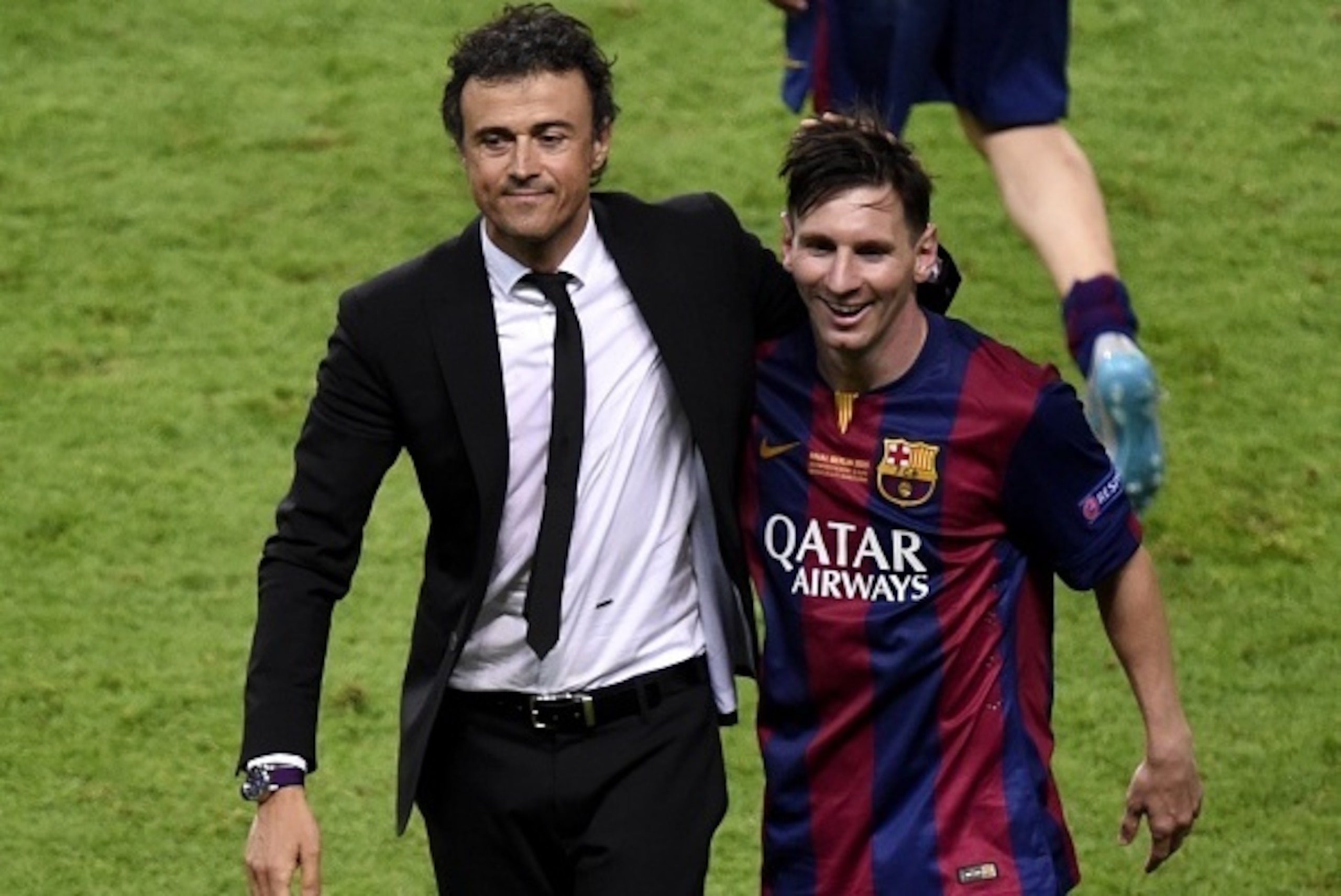 Barcelona's coach Luis Enrique and Barcelona's Argentinian forward Lionel Messi (R) celebrate after winning the UEFA Champions League Final football match between Juventus and FC Barcelona at the Olympic Stadium in Berlin on June 6, 2015.            AFP P
