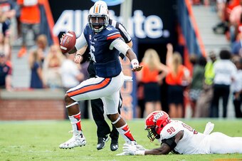 AUBURN, AL - SEPTEMBER 12: Quarterback Jeremy Johnson #6 of the Auburn Tigers scrambles to avoid a tackle by defensive end Chris Landrum #90 of the Jacksonville State Gamecocks on September 12, 2015 at Jordan-Hare Stadium in Auburn, Alabama. (Photo by Mic