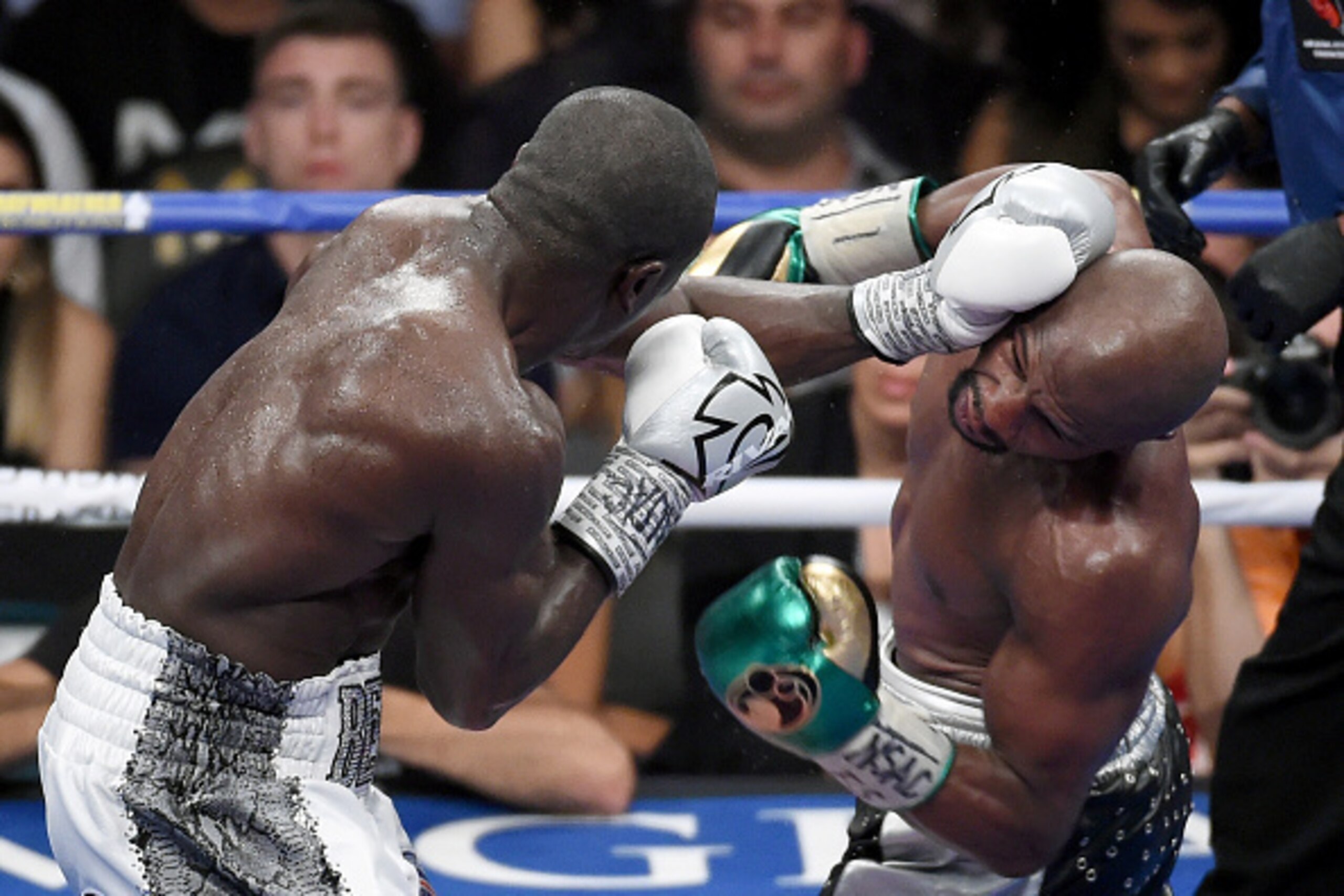 LAS VEGAS, NV - SEPTEMBER 12:  Andre Berto (L) throws a left at Floyd Mayweather Jr. in the 11th round of their WBC/WBA welterweight title fight at MGM Grand Garden Arena on September 12, 2015 in Las Vegas, Nevada. Mayweather retained his titles with a un