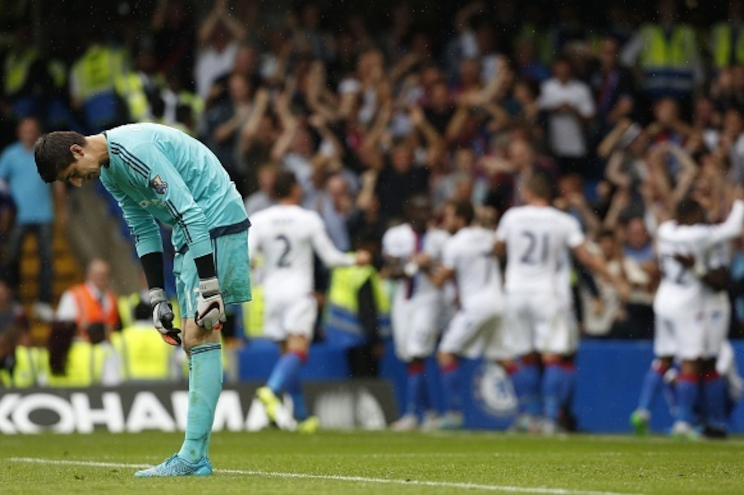 Chelseas Belgian goalkeeper Thibaut Courtois reacts as the Crystal Palace team celebrate Crystal Palaces first goal during the English Premier League football match between Chelsea and Crystal Palace at Stamford Bridge in London on August 29, 2015. Crysta Chelseas Belgian goalkeeper Thibaut Courtois reacts as the Crystal Palace team celebrate Crystal Palaces first goal during the English Premier League football match between Chelsea and Crystal Palace at Stamford Bridge in London on August 29, 2015. Crysta