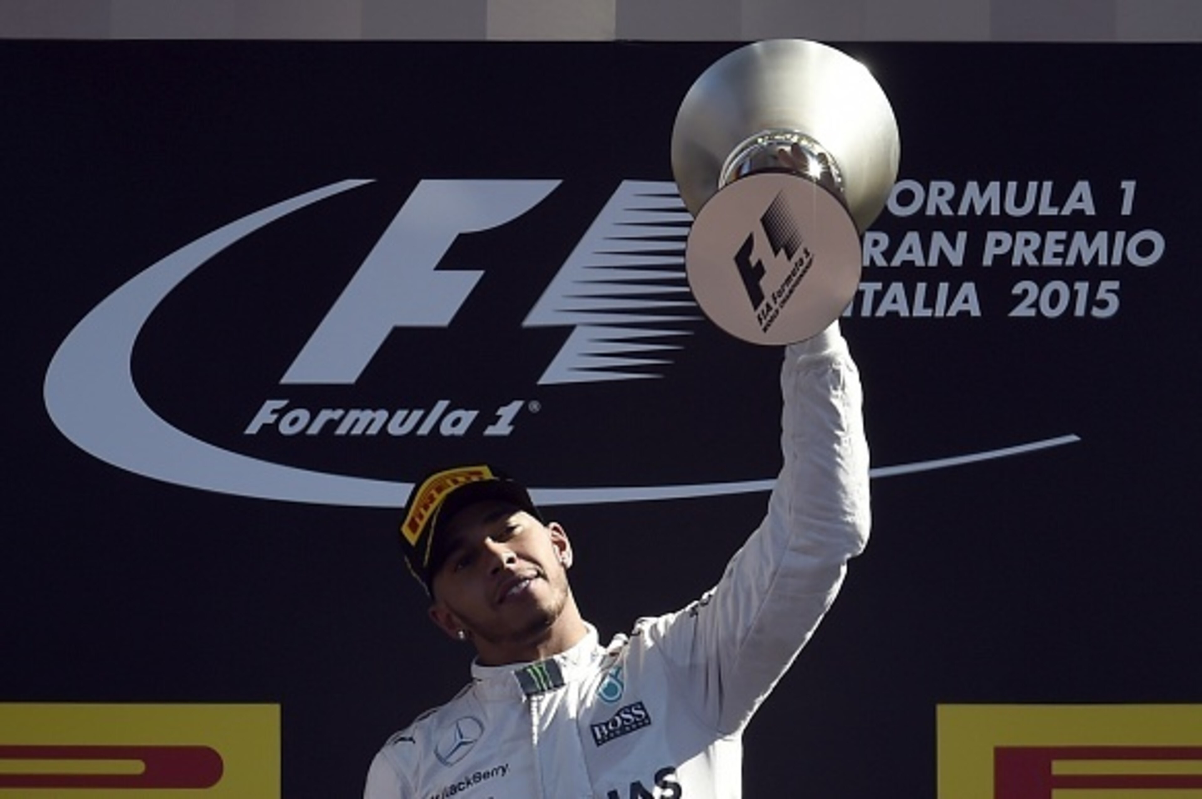 Mercedes AMG Petronas F1 Team's British driver Lewis Hamilton celebrates with his trophy on the podium after winning the Italian Formula One Grand Prix at the Autodromo Nazionale circuit in Monza on September 6, 2015. AFP PHOTO / OLIVIER MORIN        (Pho