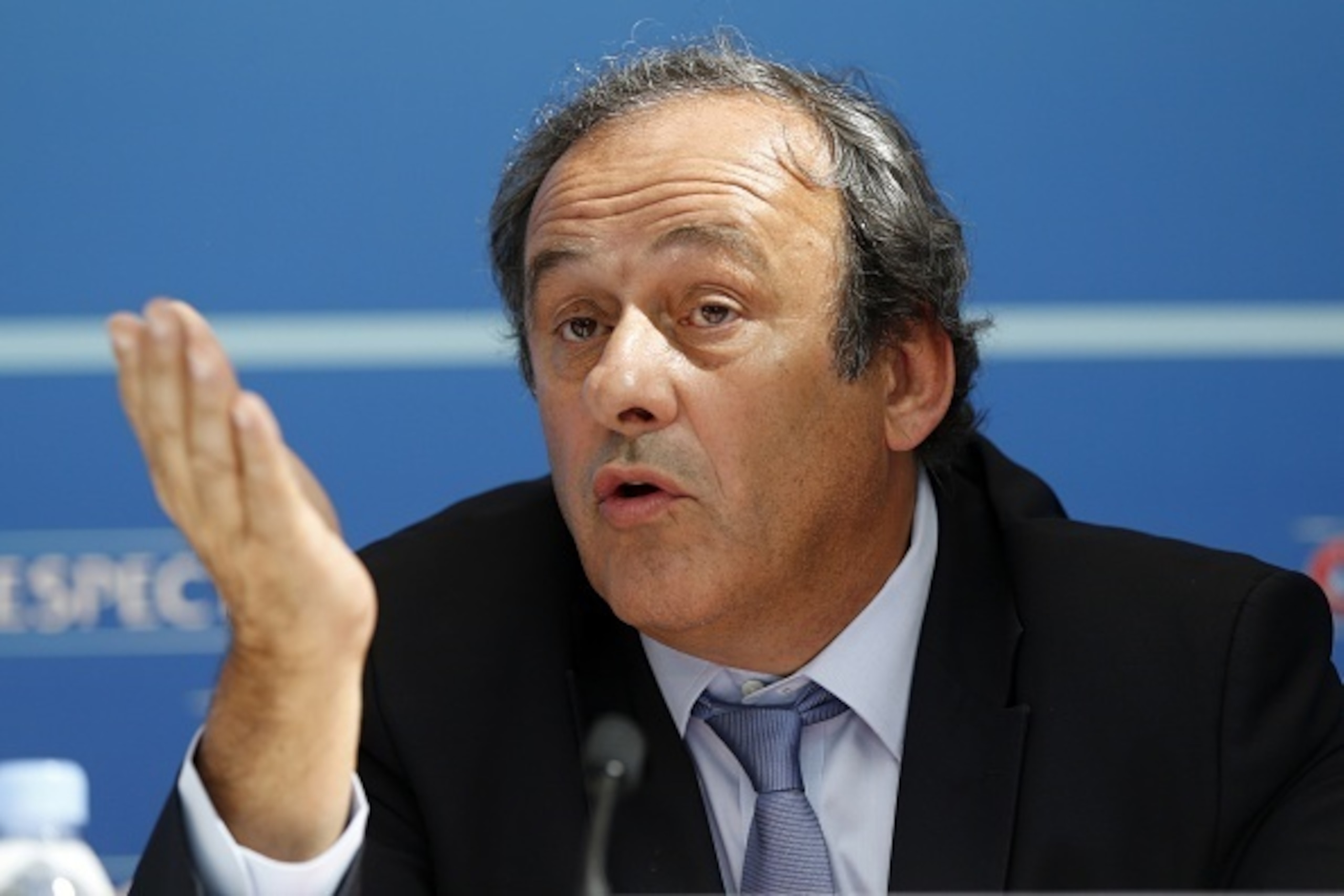 UEFA chief Michel Platini gestures as he speaks during a UEFA press conference after the draw for the UEFA Europa League football group stage 2015/16 on August 28, 2015 in Monaco.  AFP PHOTO / VALERY HACHE        (Photo credit should read VALERY HACHE/AFP