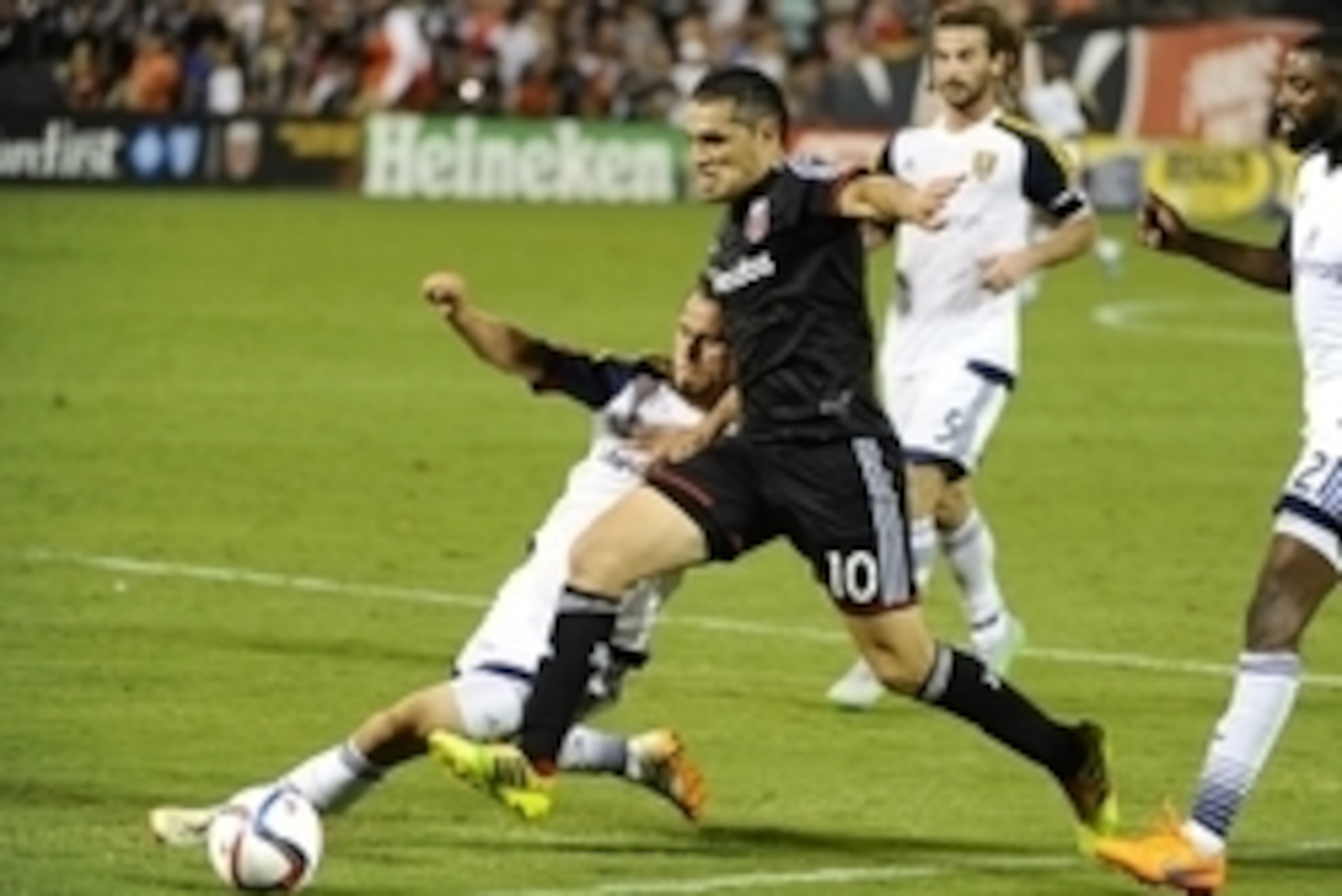 Aug 1, 2015; Washington, DC, USA; D.C. United forward Fabian Espindola (10) dribbles the ball past Real Salt Lake midfielder Luis Gil (10) during the second half at Robert F. Kennedy Memorial. D.C. United won 6 - 4. Mandatory Credit: Brad Mills-USA TODAY 