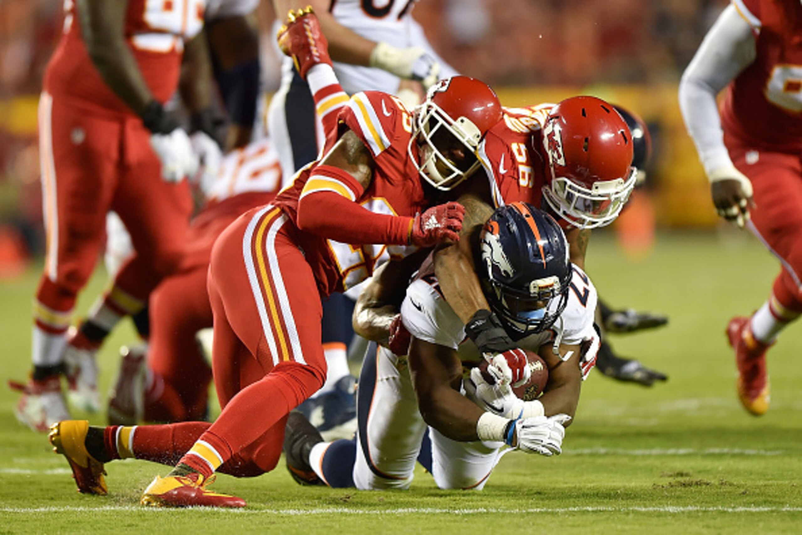 KANSAS CITY, MO - SEPTEMBER 17: Eric Berry #29 and Derrick Johnson #56 of the Kansas City Chiefs tackle C.J. Anderson #22 of the Denver Broncos during the game at Arrowhead Stadium on September 17, 2015 in Kansas City, Missouri. (Photo by Peter Aiken/Gett