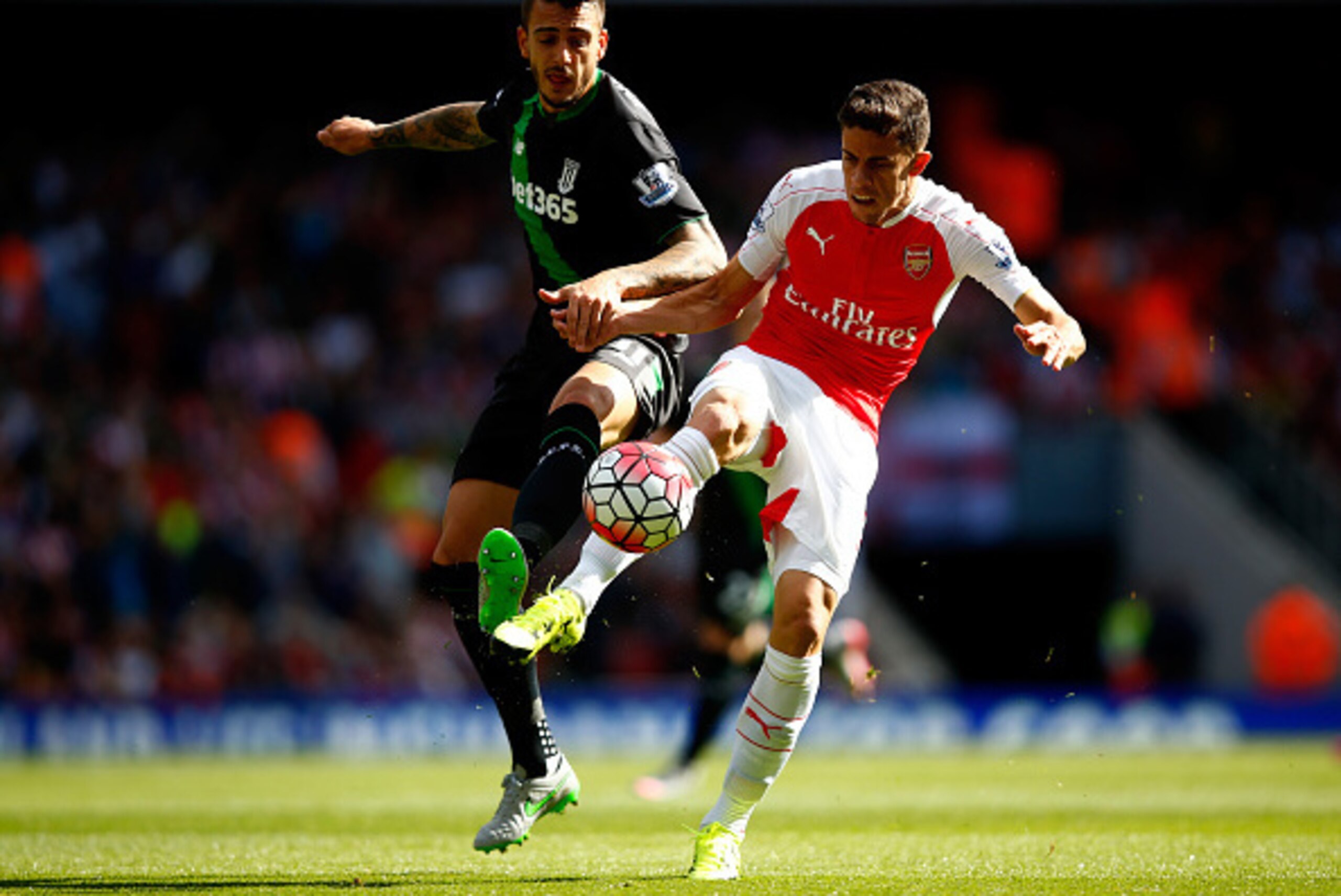 LONDON, ENGLAND - SEPTEMBER 12: Joselu of Stoke City challenges Gabriel Paulista of Arsenal during the Barclays Premier League match between Arsenal and Stoke City at the Emirates Stadium on September 12, 2015 in London, United Kingdom.  (Photo by Clive R