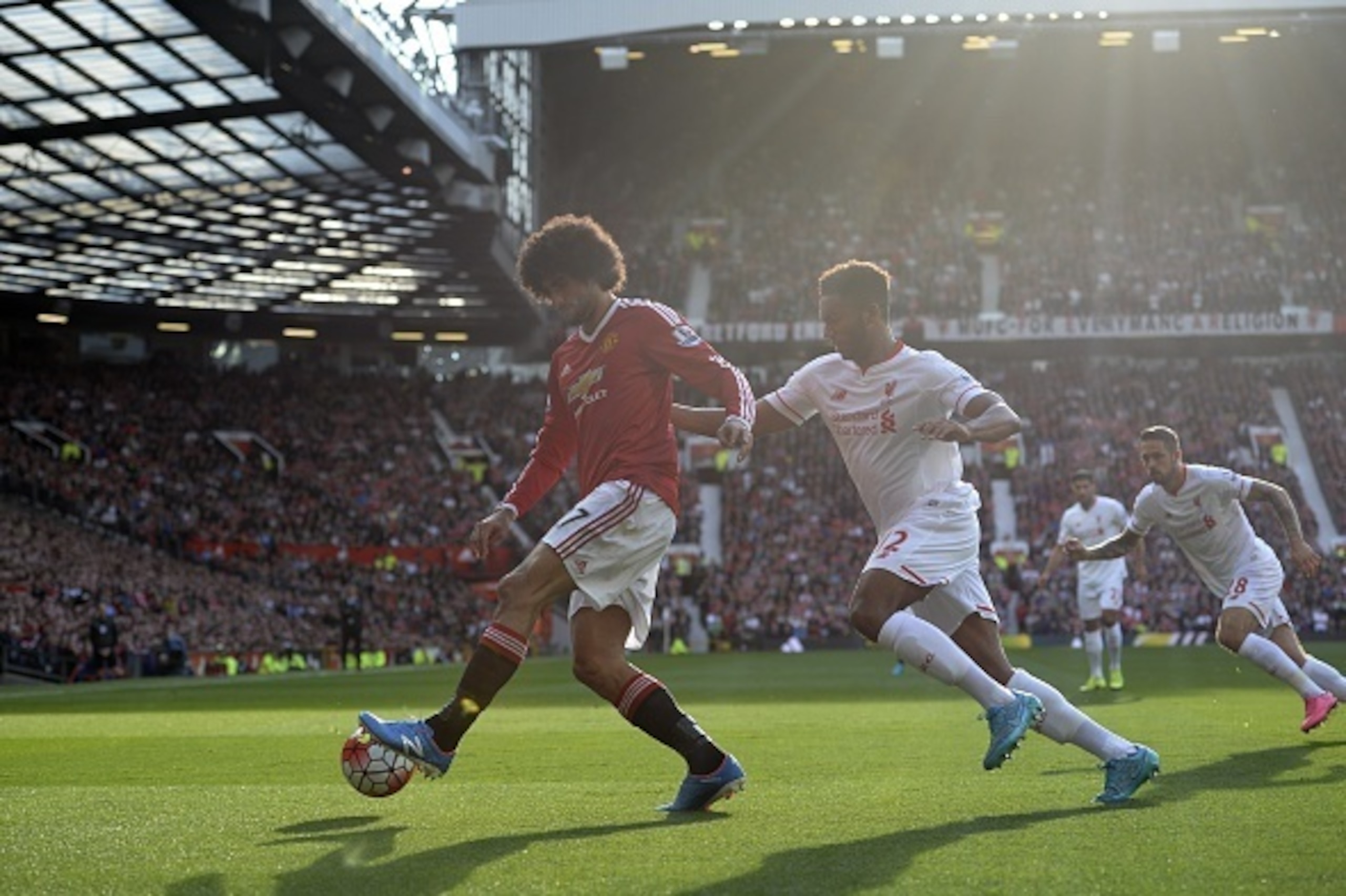 Manchester United's Belgian midfielder Marouane Fellaini (L) is persued by Liverpool's English defender Joe Gomez (R) during the English Premier League football match between Manchester United and Liverpool at Old Trafford in Manchester, north west Englan
