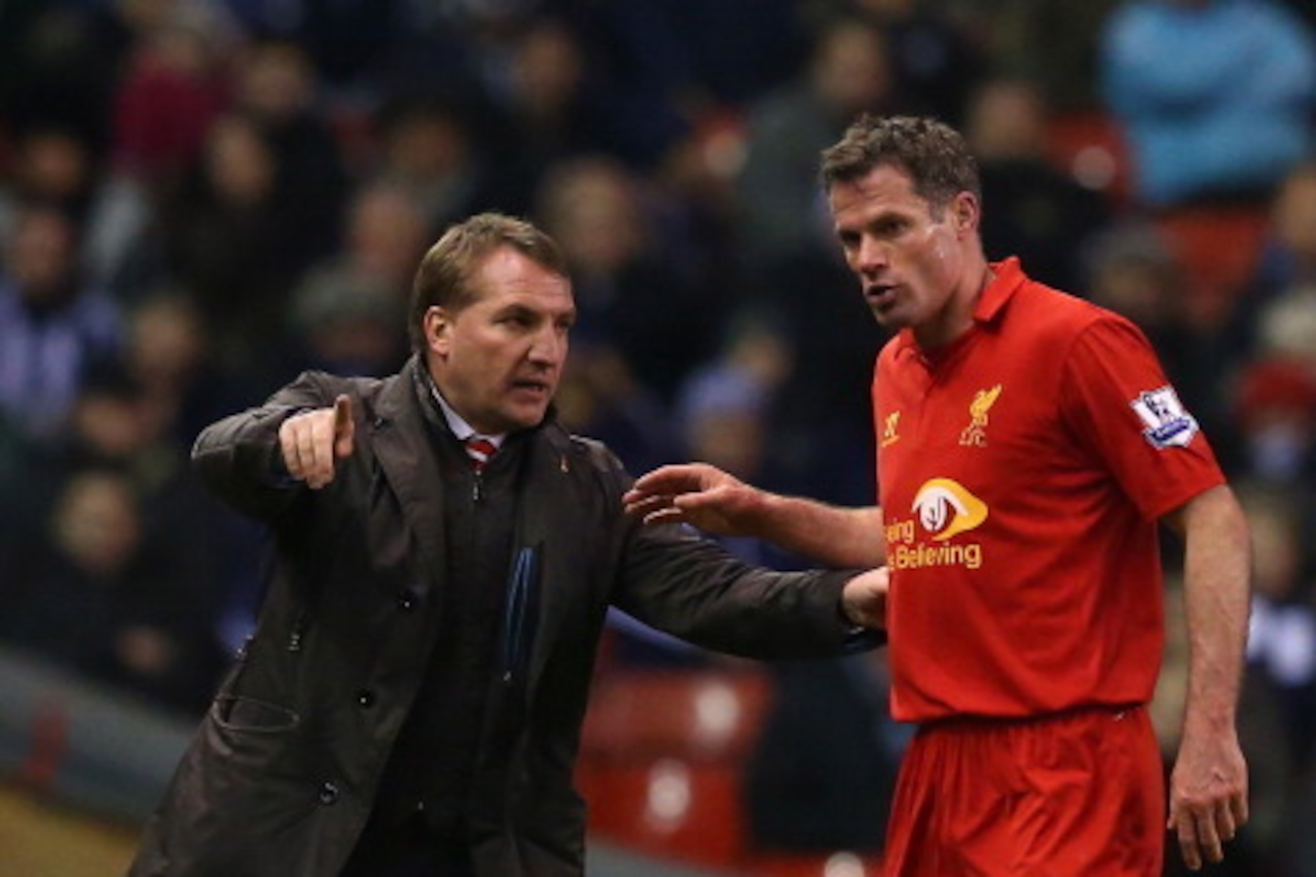 LIVERPOOL, ENGLAND - FEBRUARY 11:  Liverpool Manager Brendan Rodgers gestures to Jamie Carragher of Liverpool during the Barclays Premier League match between Liverpool and West Bromwich Albion at Anfield on February 11, 2013 in Liverpool, England.  (Phot