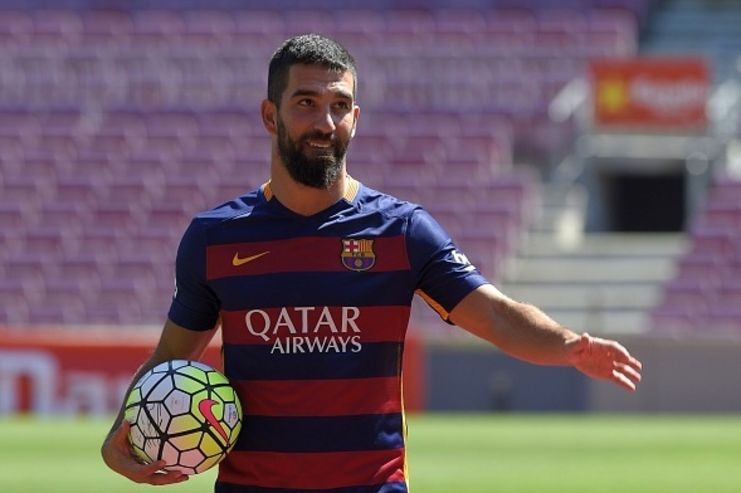 Barcelona's new player Turkish Arda Turan gestures during his official presentation at the Camp Nou stadium in Barcelona, after signing his new contract with the Catalan club, on July 10, 2015. Barcelona will keep more than 60 million euros ($65 million) 