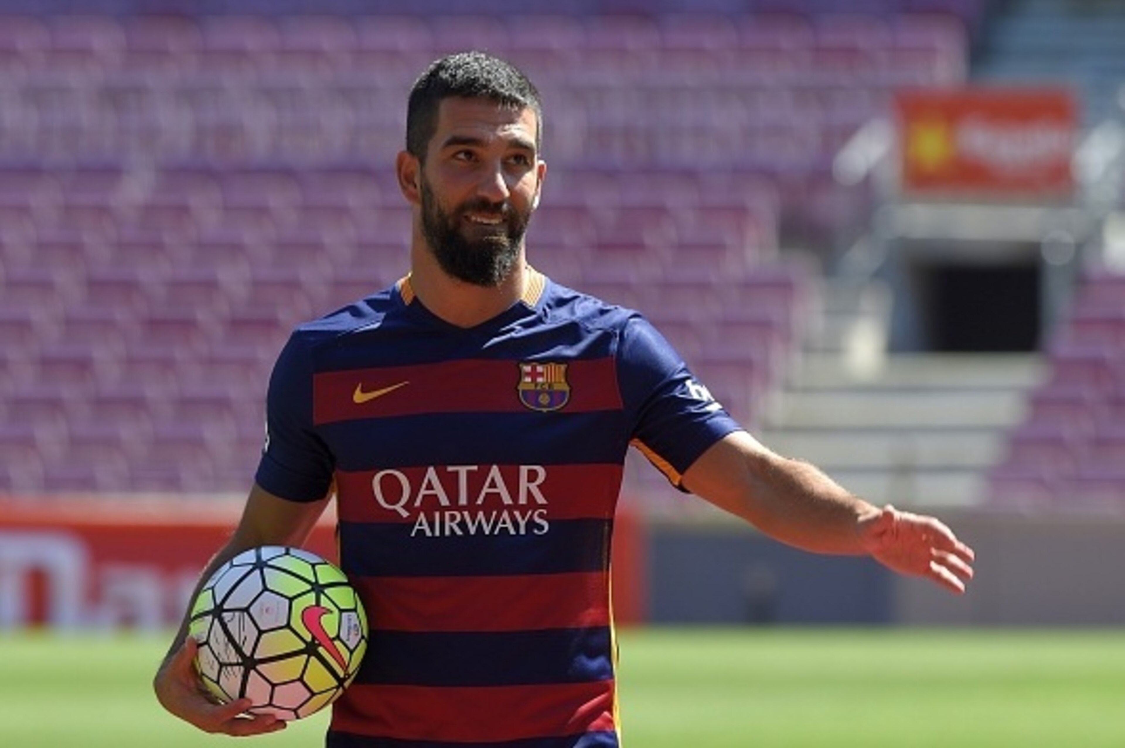 Barcelona's new player Turkish Arda Turan gestures during his official presentation at the Camp Nou stadium in Barcelona, after signing his new contract with the Catalan club, on July 10, 2015. Barcelona will keep more than 60 million euros ($65 million) Barcelona's new player Turkish Arda Turan gestures during his official presentation at the Camp Nou stadium in Barcelona, after signing his new contract with the Catalan club, on July 10, 2015. Barcelona will keep more than 60 million euros ($65 million)