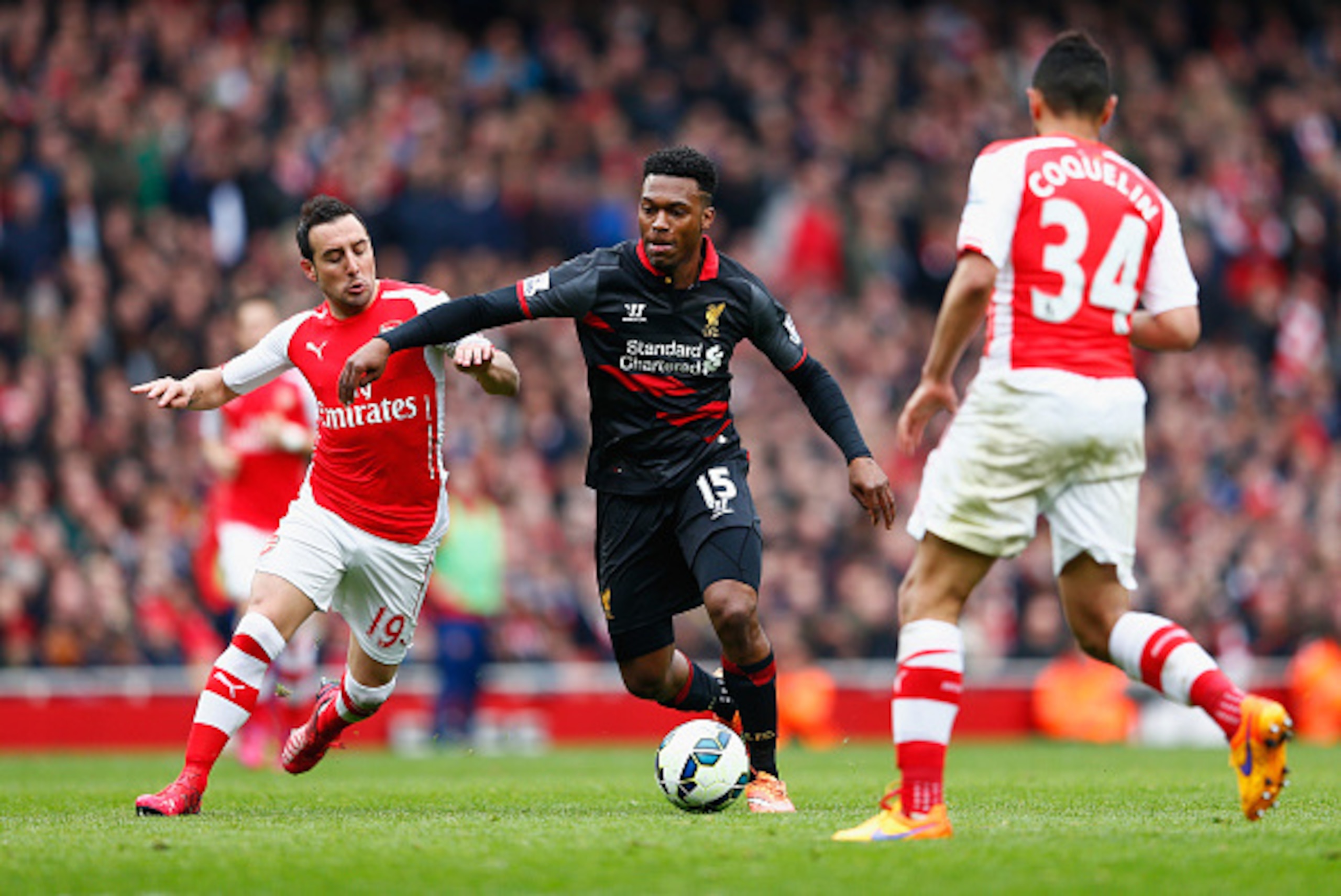 LONDON, ENGLAND - APRIL 04:  Santi Cazorla of Arsenal marshalls Daniel Sturridge of Liverpool during the Barclays Premier League match between Arsenal and Liverpool at Emirates Stadium on April 4, 2015 in London, England.  (Photo by Julian Finney/Getty Im