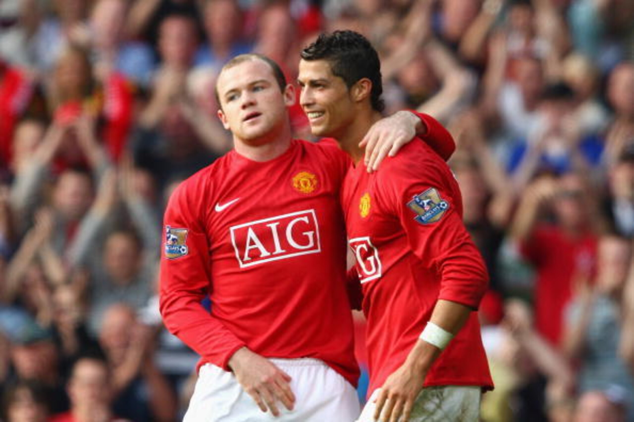 MANCHESTER, UNITED KINGDOM - SEPTEMBER 27:  Wayne Rooney of Manchester United celebrates scoring his team's second goal with team mate Cristiano Ronaldo (R) during the Barclays Premier League match between Manchester United and Bolton Wanderers at Old Tra