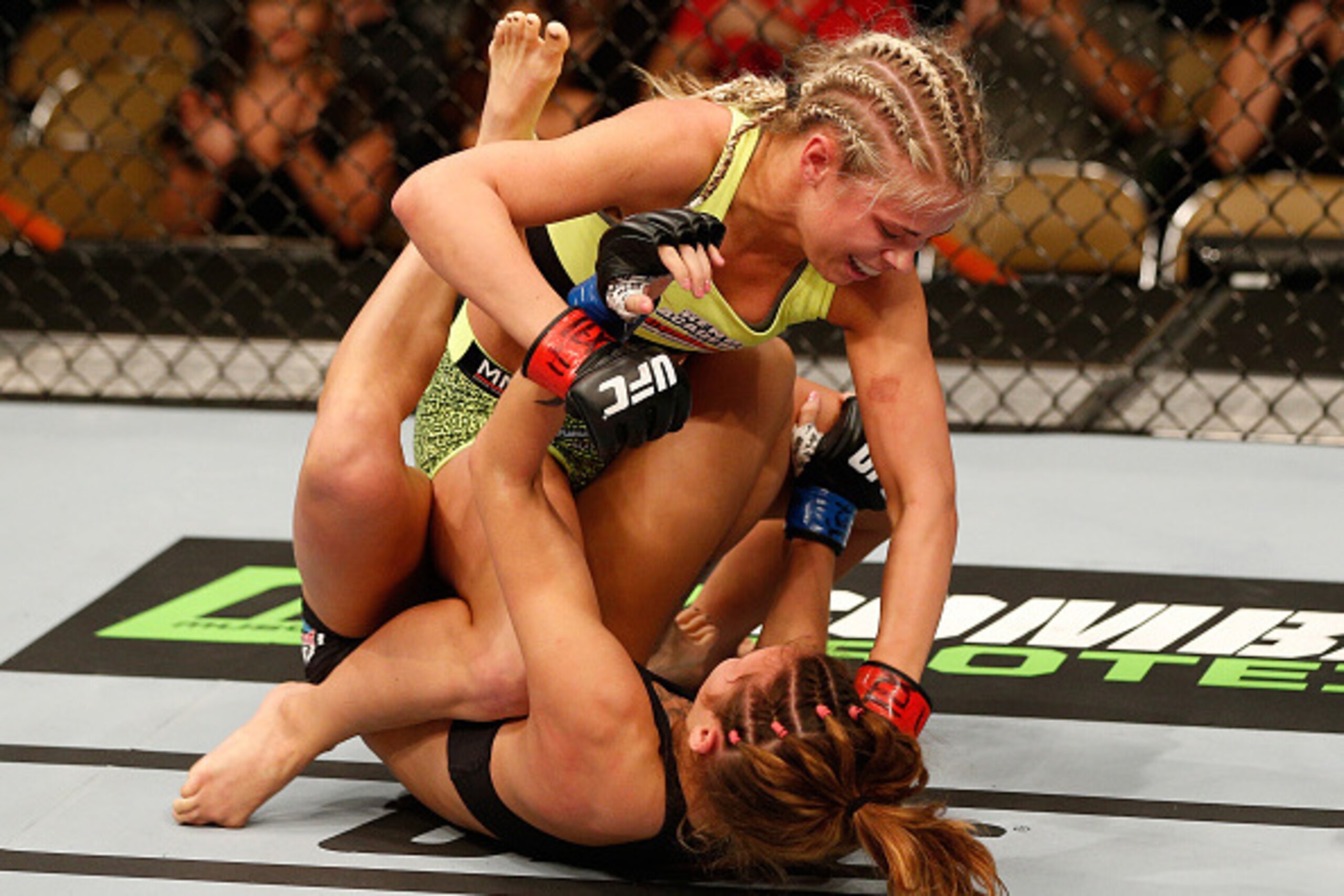 AUSTIN, TX - NOVEMBER 22:  (L-R) Paige VanZant punches Kailin Curran in their women's bantamweight bout during the UFC Fight Night event at The Frank Erwin Center on November 22, 2014 in Austin, Texas.  (Photo by Josh Hedges/Zuffa LLC/Zuffa LLC via Getty 