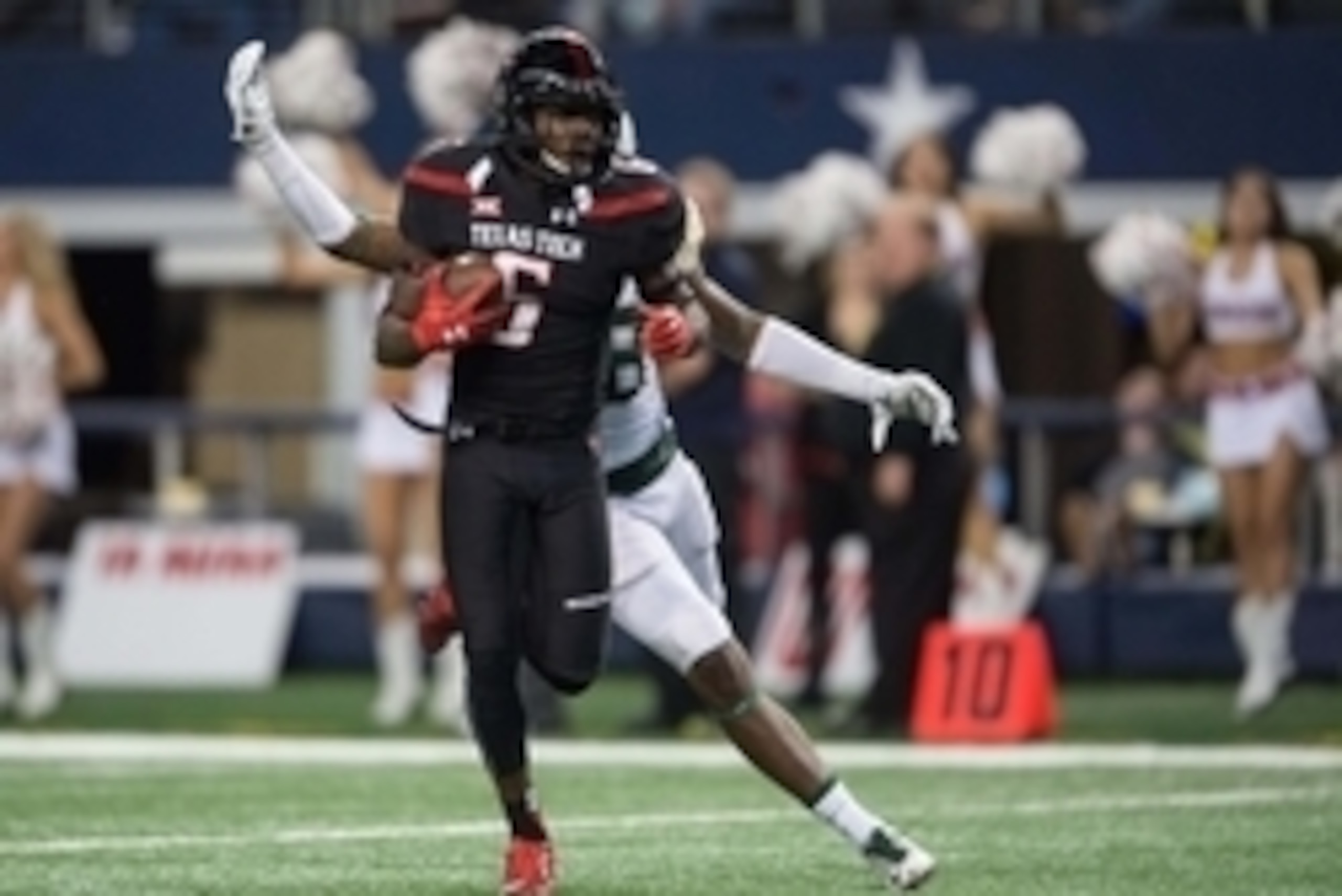 Nov 29, 2014; Arlington, TX, USA; Texas Tech Red Raiders wide receiver Devin Lauderdale (6) catches a touchdown pass past Baylor Bears safety Orion Stewart (28) during the second half at AT&T Stadium. The Bears defeated the Red Raiders 48-46. Mandatory Cr