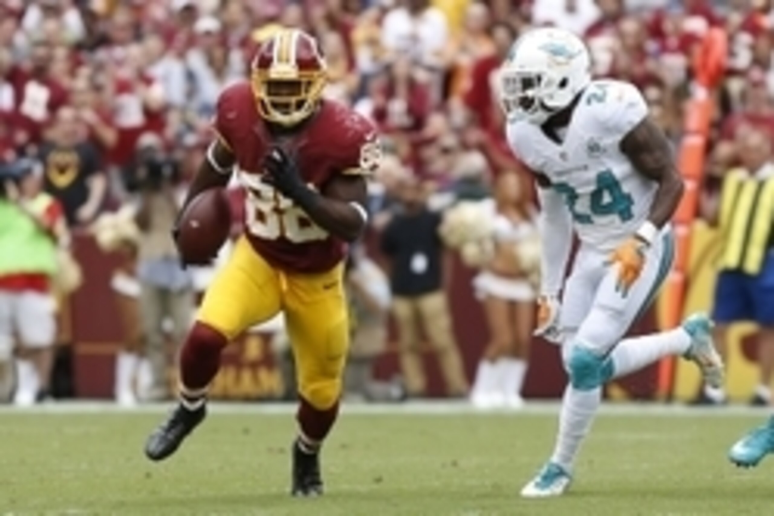 Sep 13, 2015; Landover, MD, USA; Washington Redskins wide receiver Pierre Garcon (88) runs with the ball as Miami Dolphins defensive back Brice McCain (24) chases in the second quarter at FedEx Field. Mandatory Credit: Geoff Burke-USA TODAY Sports