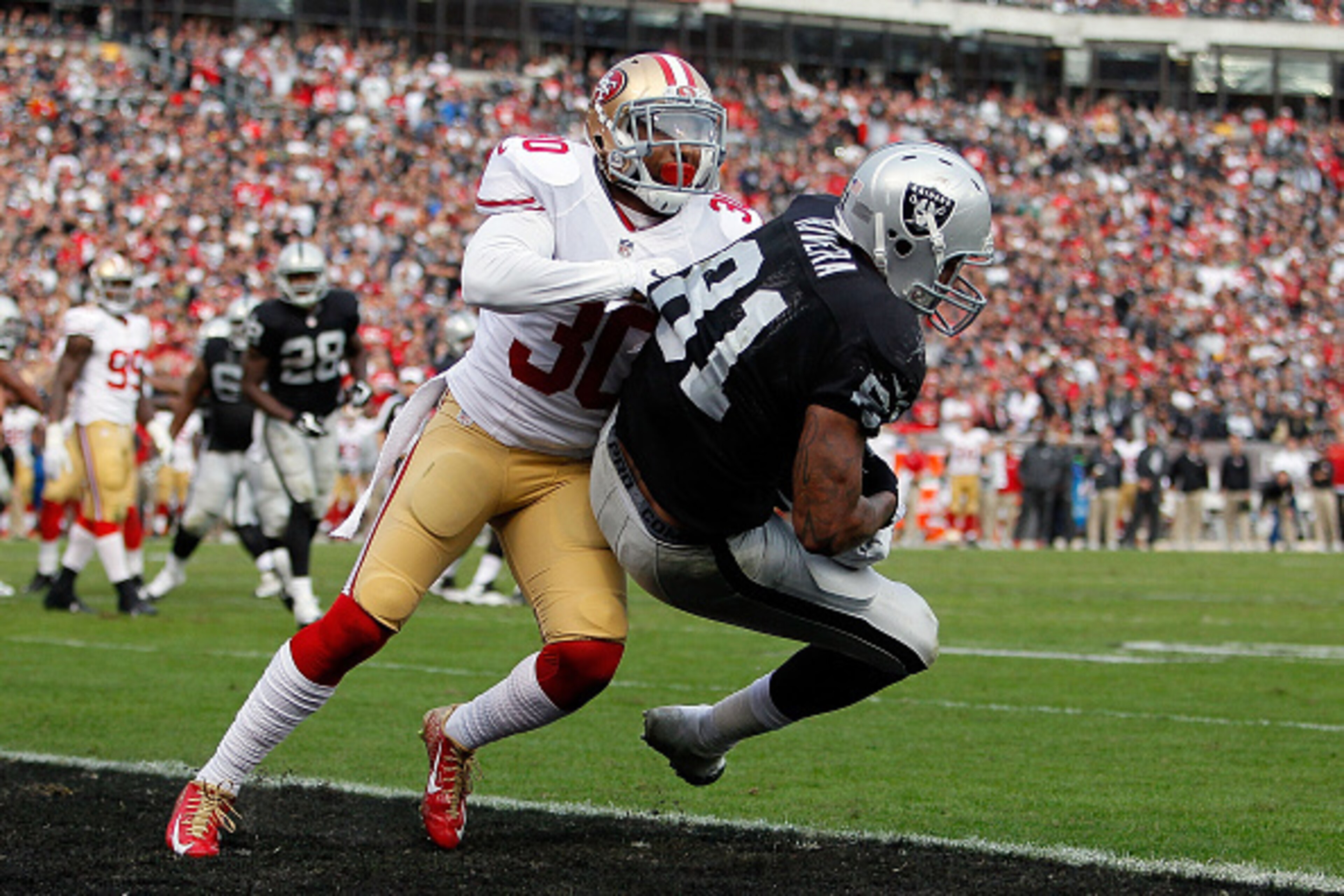 OAKLAND, CA - DECEMBER 07: Mychal Rivera #81 of the Oakland Raiders scores a touchdown in the fourth quarter in front of Leon McFadden #30 of the San Francisco 49ers at O.co Coliseum on December 7, 2014 in Oakland, California. (Photo by Brian Bahr/Gett OAKLAND, CA - DECEMBER 07: Mychal Rivera #81 of the Oakland Raiders scores a touchdown in the fourth quarter in front of Leon McFadden #30 of the San Francisco 49ers at O.co Coliseum on December 7, 2014 in Oakland, California. (Photo by Brian Bahr/Gett