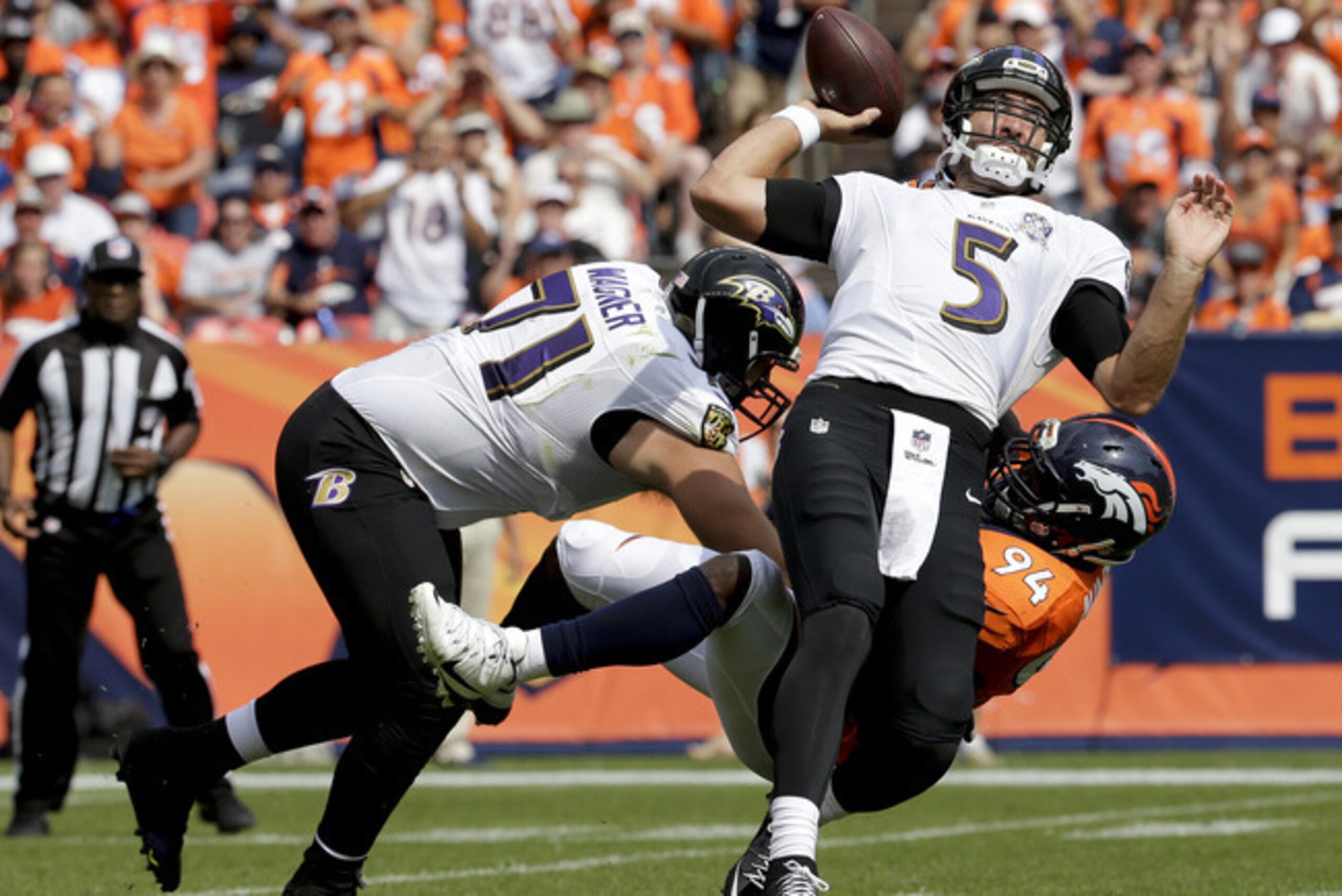 Quarterback Joe Flacco gets sacked.