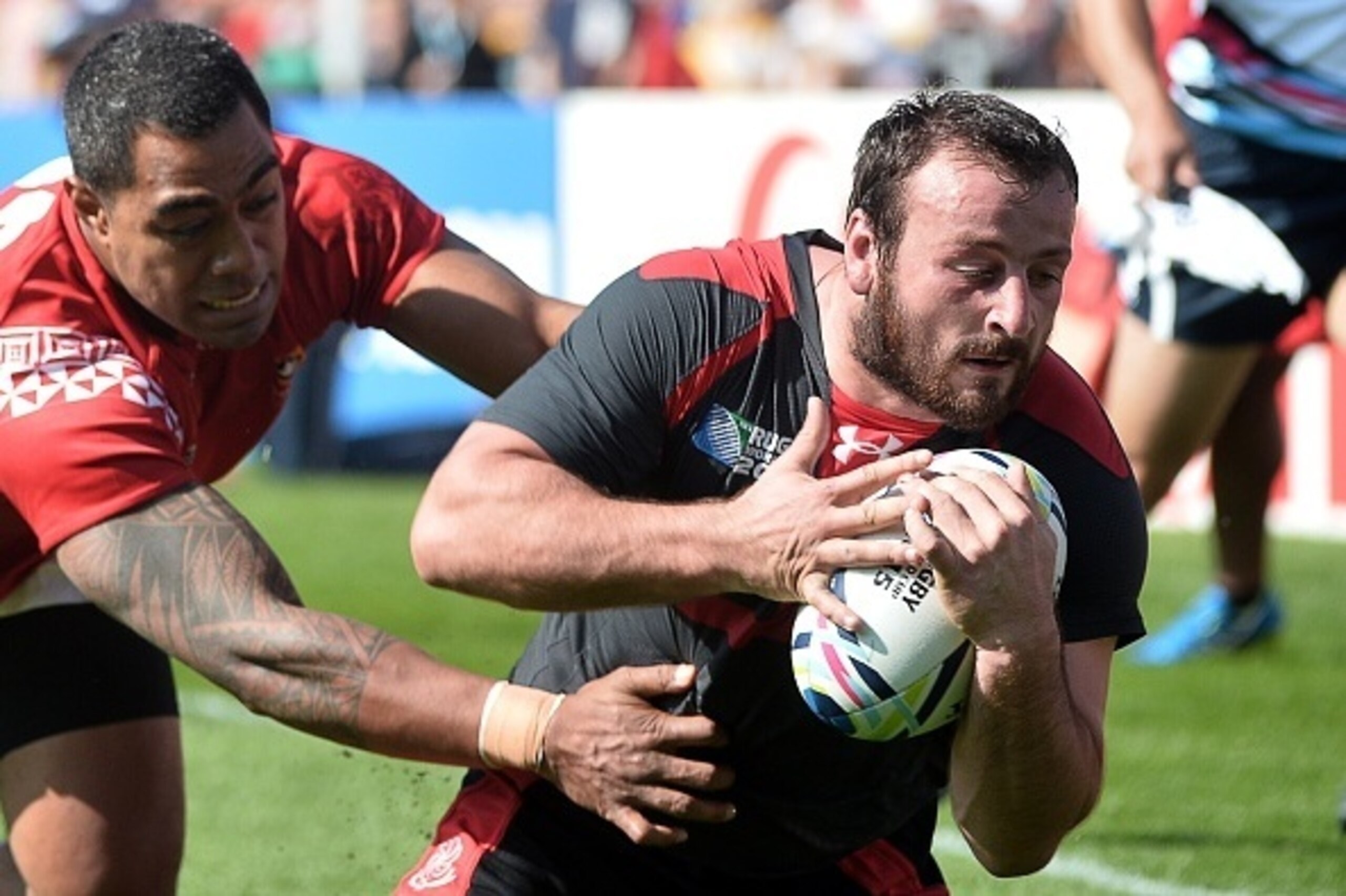 Georgia's flanker Giorgi Tkhilaishvili (R) runs to score a try  during a Pool C match of the 2015 Rugby World Cup between Tonga and Georgia at Kingsholm stadium in Gloucester, west England, on September 19, 2015.  AFP PHOTO / BERTRAND LANGLOIS

RESTRICTED