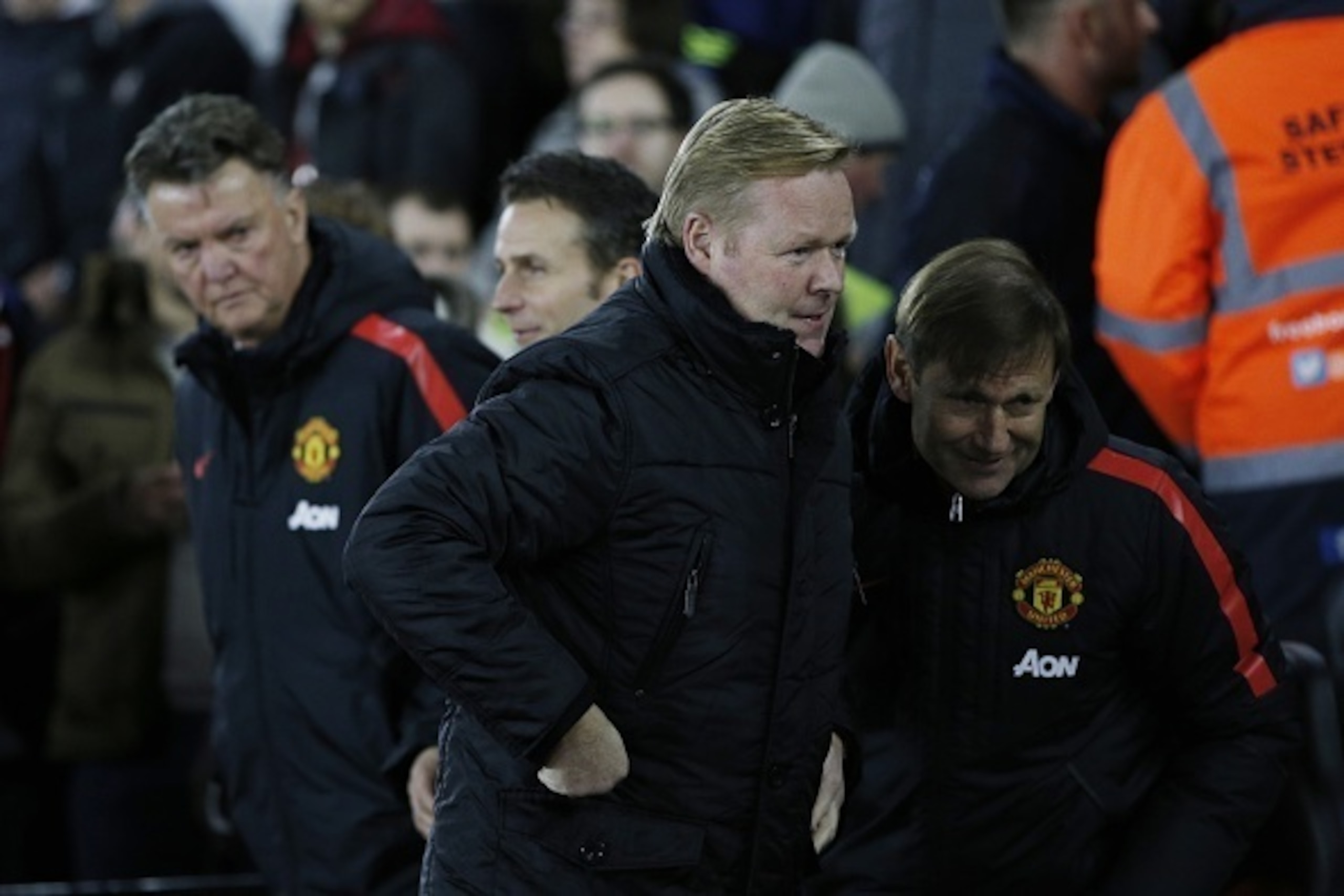Manchester United's Dutch manager Louis van Gaal (L) looks toward Southampton's Dutch manager Ronald Koeman (C) as they arrive in their respective dug-outs before kick off of the English Premier League football match between Southampton and Manchester Uni