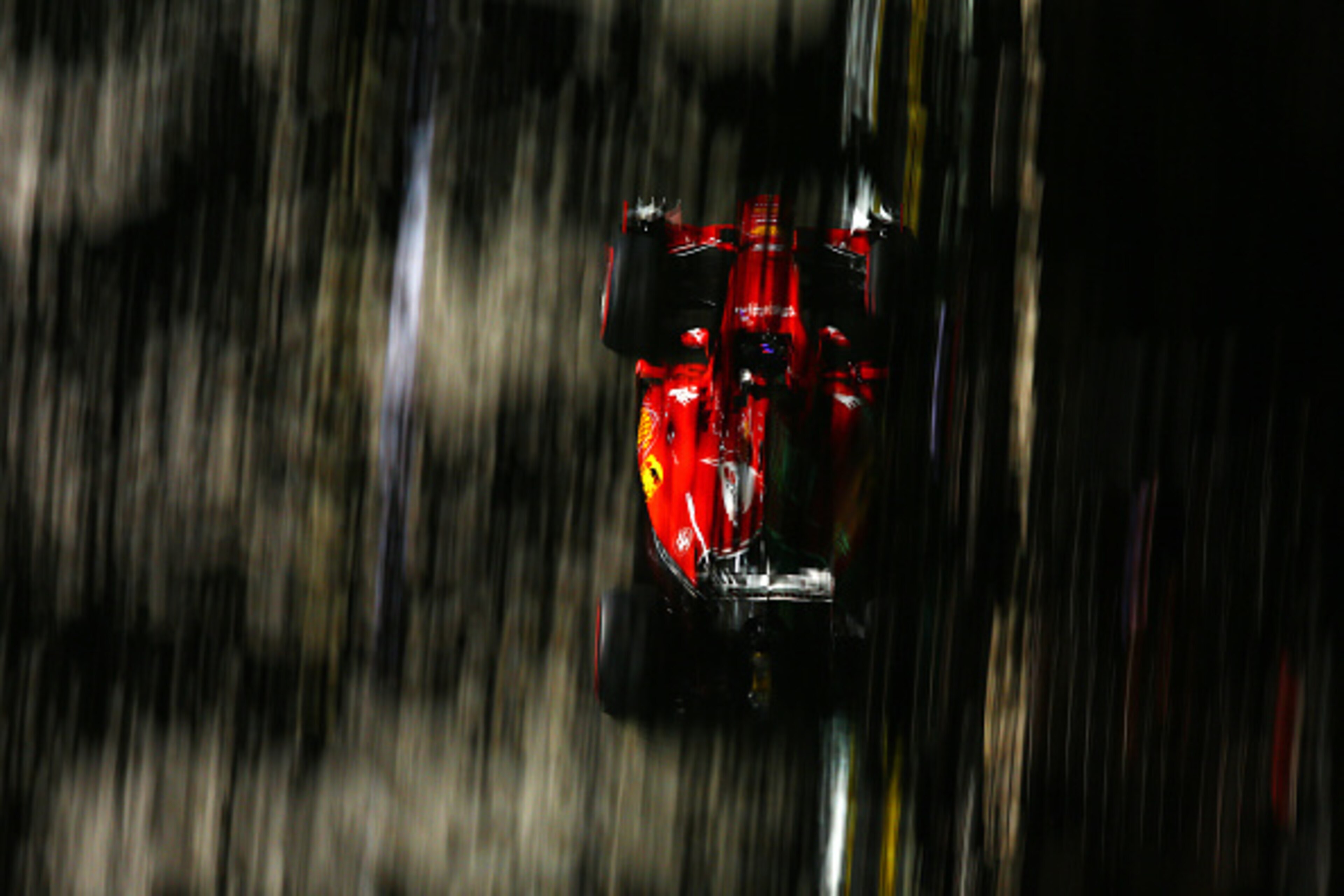SINGAPORE - SEPTEMBER 18:  Sebastian Vettel of Germany and Ferrari drives during practice for the Formula One Grand Prix of Singapore at Marina Bay Street Circuit on September 18, 2015 in Singapore.  (Photo by Clive Mason/Getty Images)