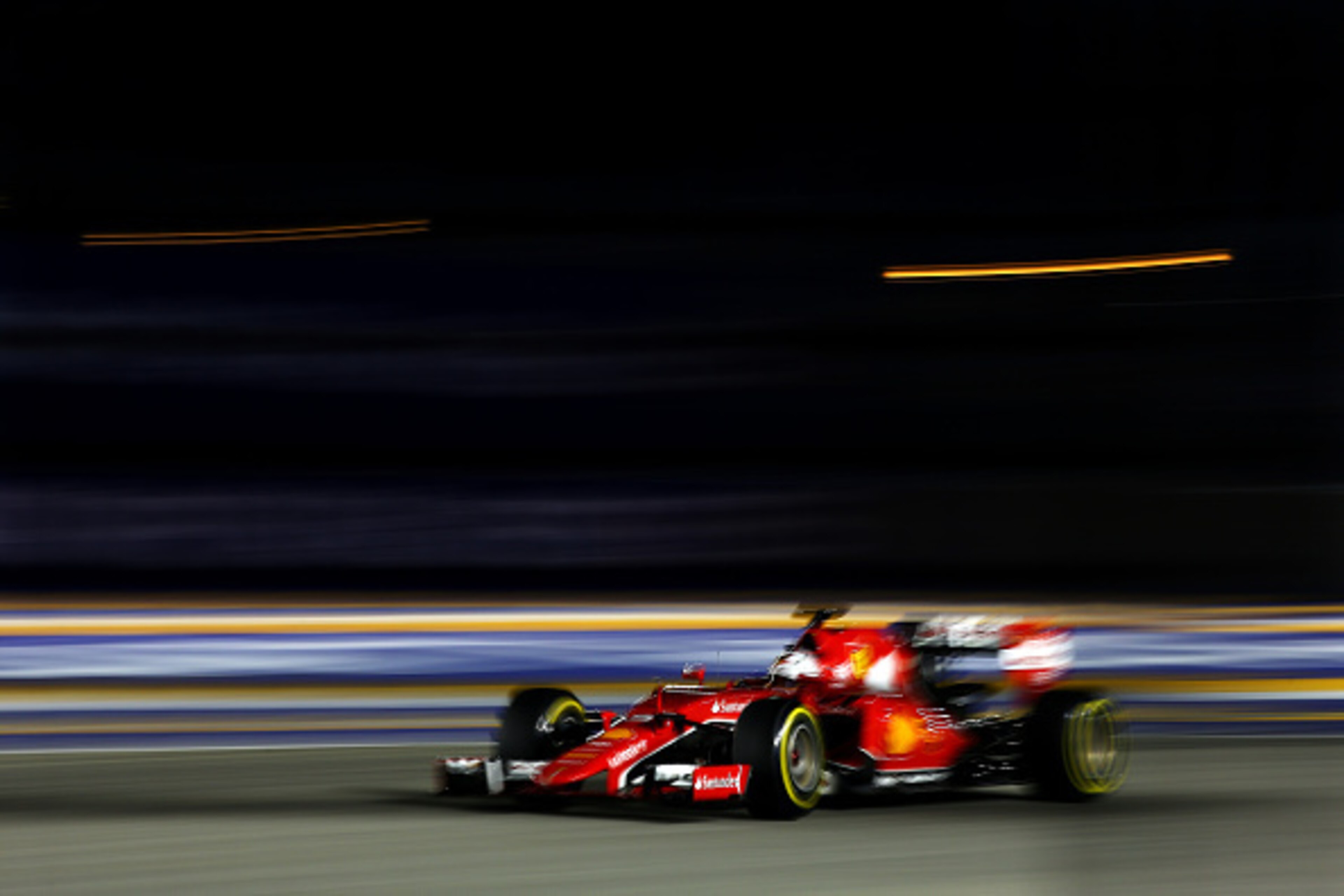 SINGAPORE - SEPTEMBER 19:  Sebastian Vettel of Germany and Ferrari drives during qualifying for the Formula One Grand Prix of Singapore at Marina Bay Street Circuit on September 19, 2015 in Singapore.  (Photo by Mark Thompson/Getty Images)
