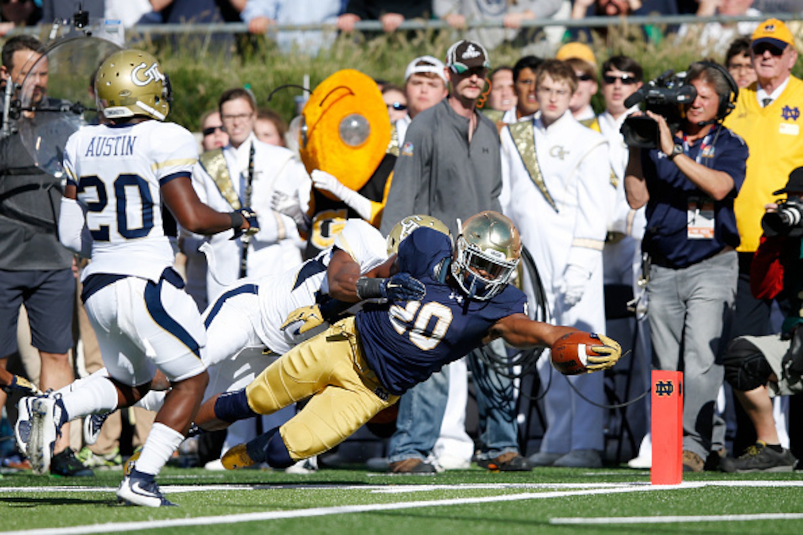 SOUTH BEND, IN - SEPTEMBER 19: C.J. Prosise #20 of the Notre Dame Fighting Irish dives into the end zone for a 17-yard touchdown against the Georgia Tech Yellow Jackets in the second quarter at Notre Dame Stadium on September 19, 2015 in South Bend, India