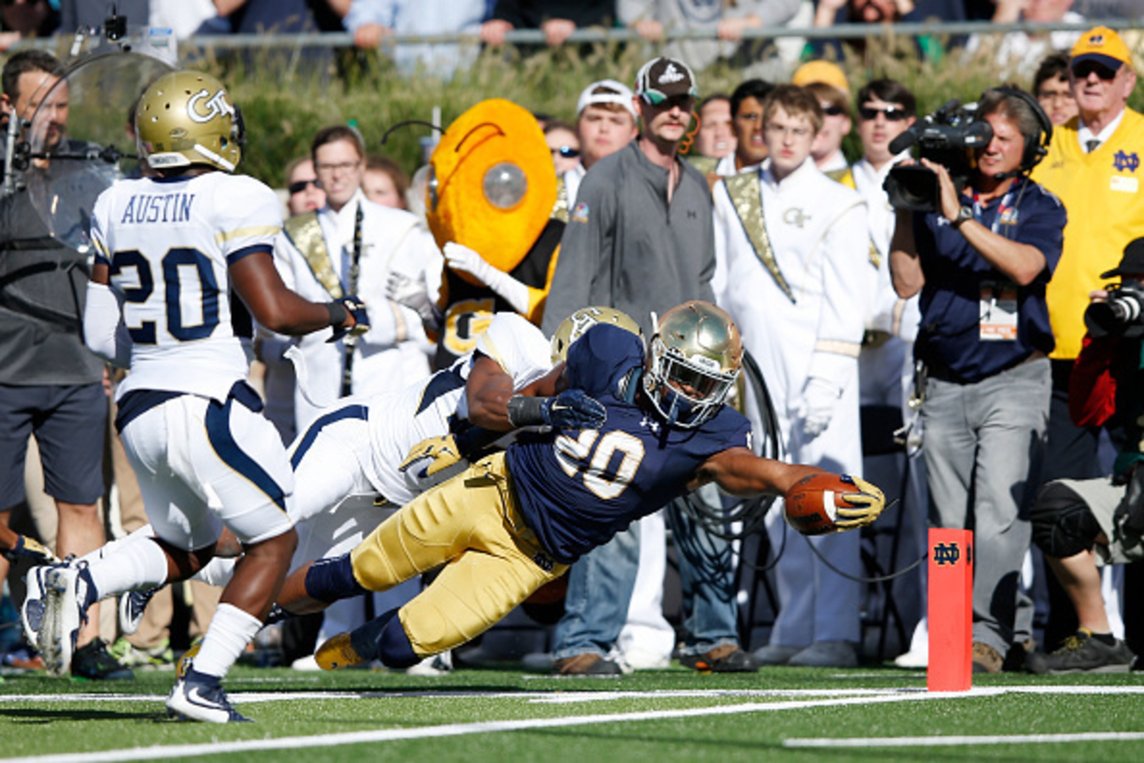 SOUTH BEND, IN - SEPTEMBER 19: C.J. Prosise #20 of the Notre Dame Fighting Irish dives into the end zone for a 17-yard touchdown against the Georgia Tech Yellow Jackets in the second quarter at Notre Dame Stadium on September 19, 2015 in South Bend, India