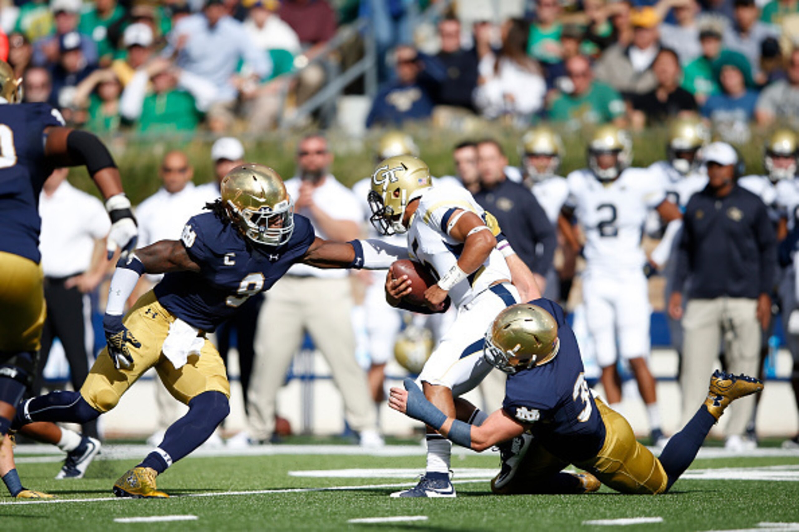 SOUTH BEND, IN - SEPTEMBER 19: Jaylon Smith #9 and Joe Schmidt #38 of the Notre Dame Fighting Irish tackle Justin Thomas #5 of the Georgia Tech Yellow Jackets for a loss in the second quarter at Notre Dame Stadium on September 19, 2015 in South Bend, Indi