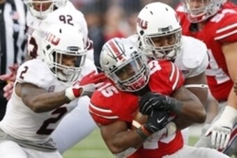 Sep 19, 2015; Columbus, OH, USA; Ohio State Buckeyes running back Ezekiel Elliott (15) runs into Northern Illinois Huskies safety Marlon Moore (2) and Huskies linebacker Boomer Mays (45)during the second half at Ohio Stadium. The Ohio State Buckeyes won 2